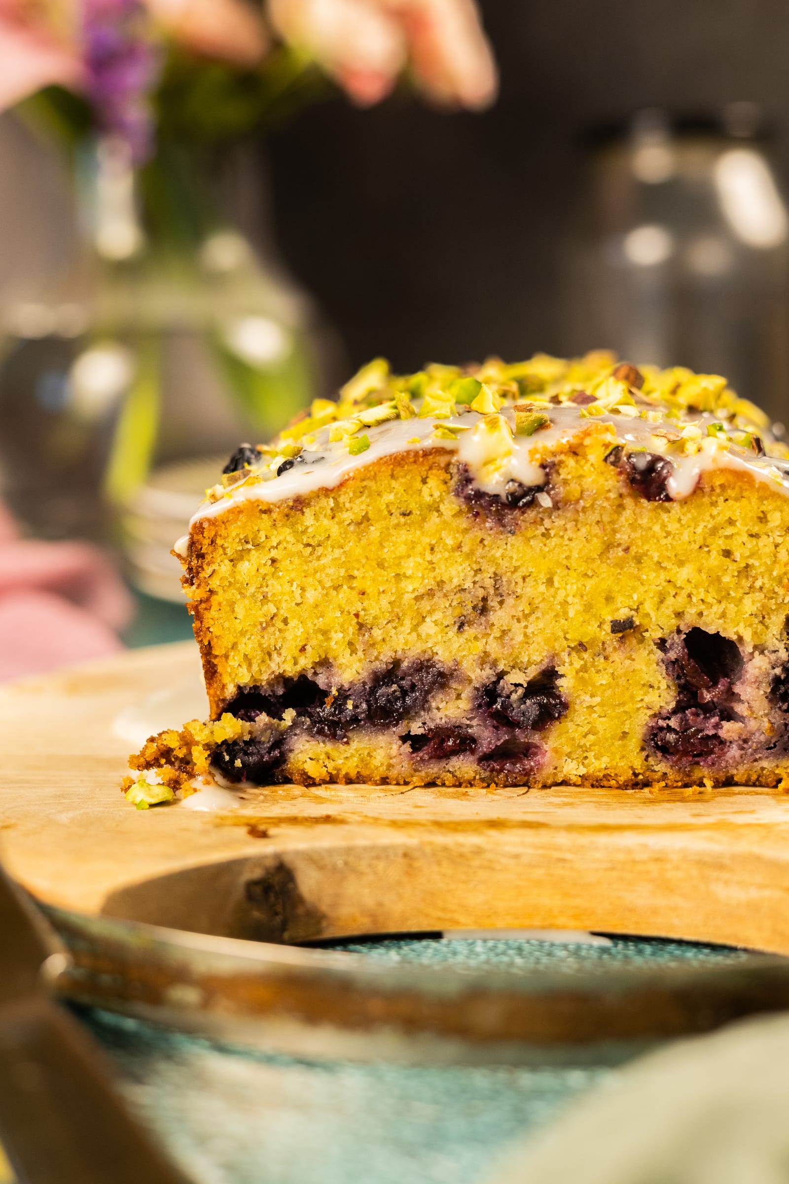 The loaf cut open to show a golden crumb studded with blueberries