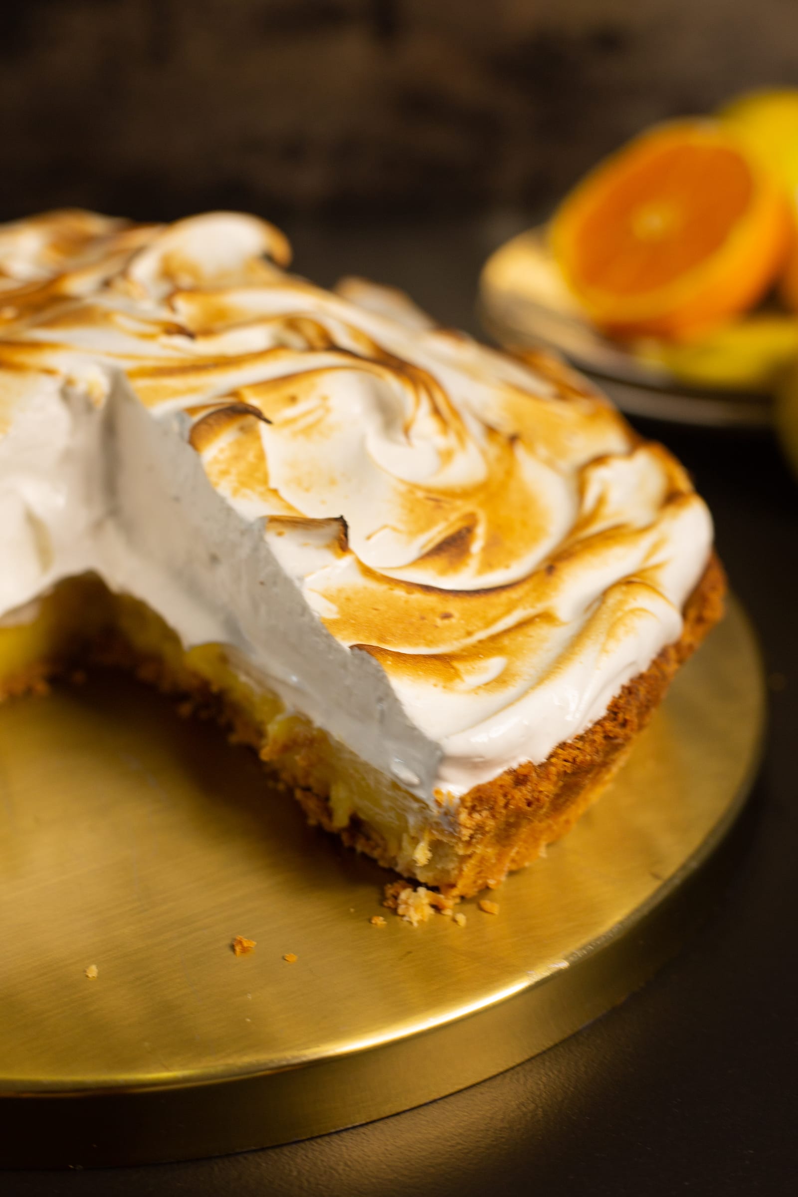 The cut face of the lemon meringue pie, showing the meringue over the lemon curd