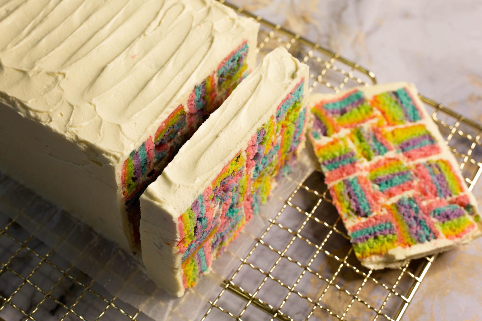Close-up of the rainbow squares in the cut face of a rainbow coconut layer cake