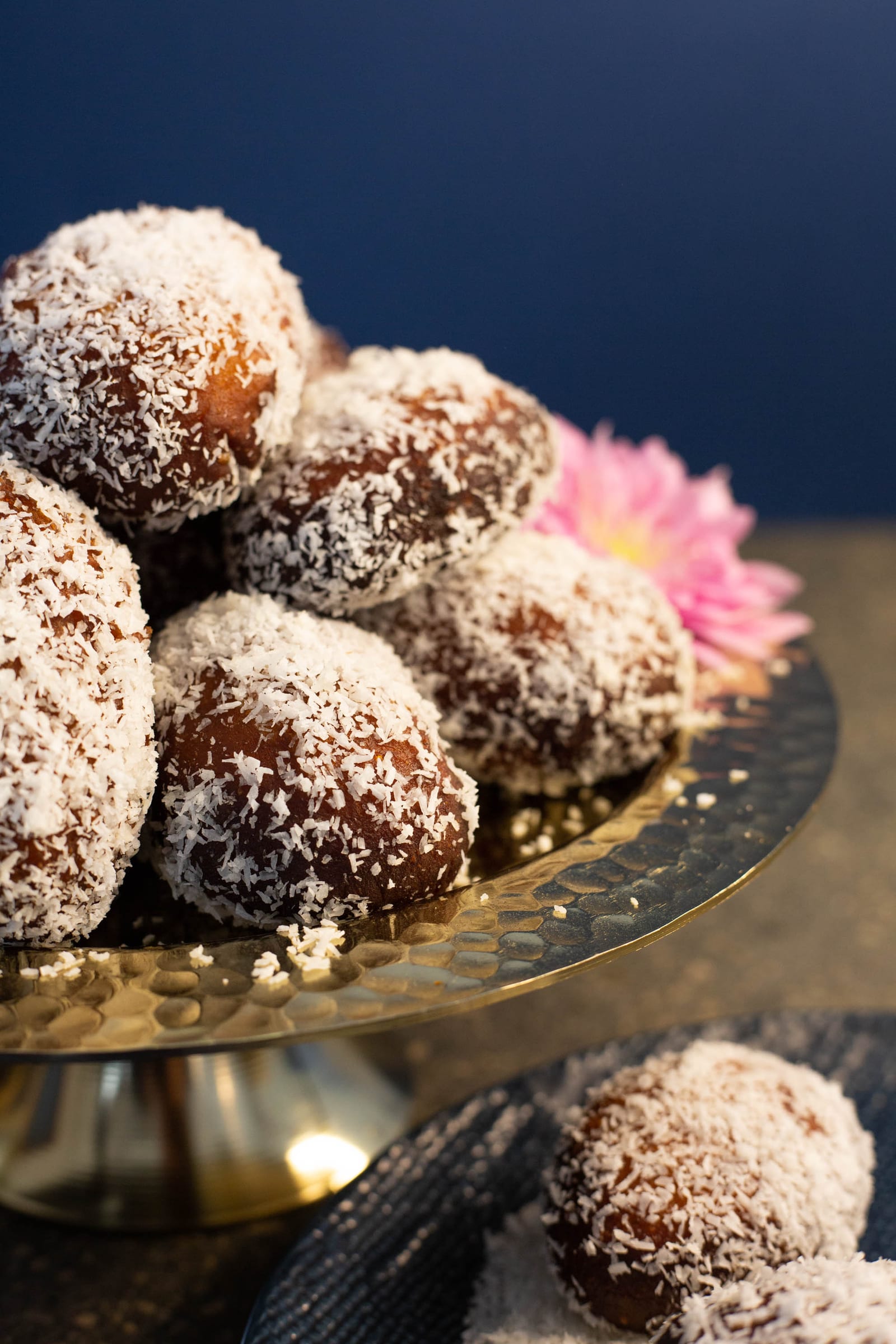 Coconut-covered Cape Malay koesisters piled high in a brass bowl