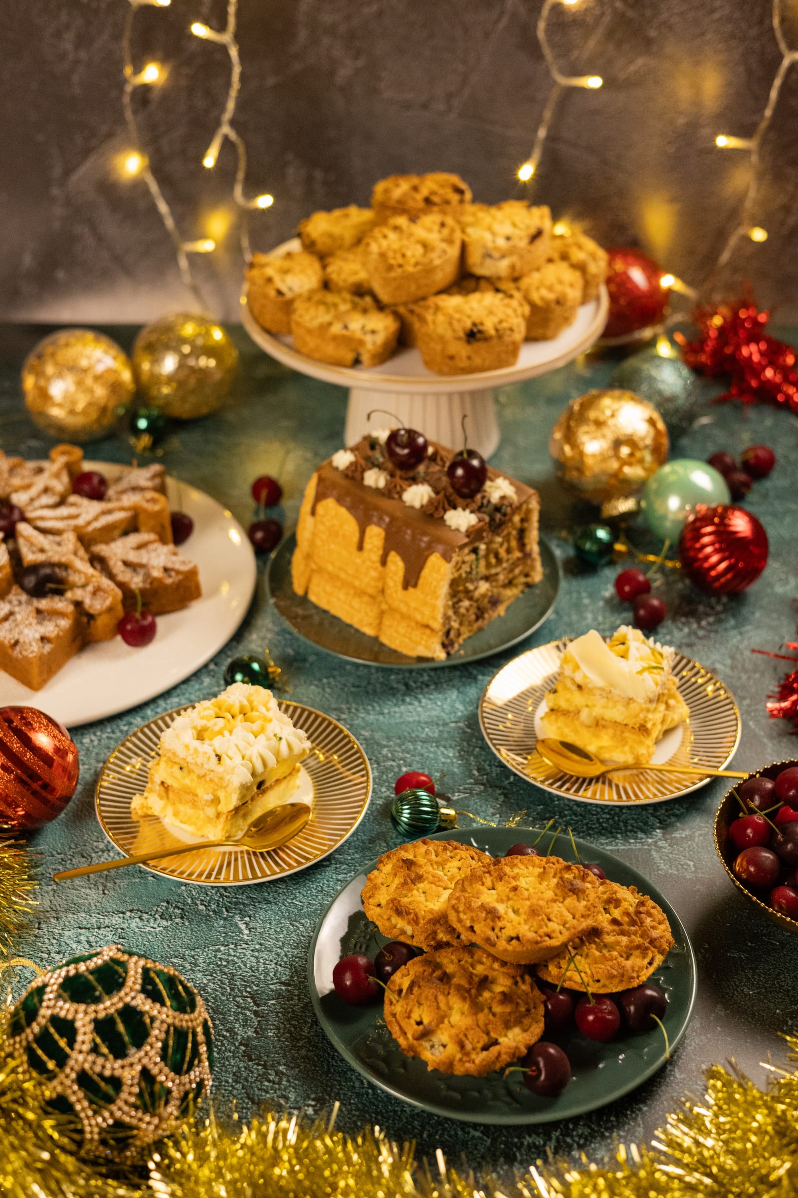 A Christmas table of bakes with baubles and fairy lights