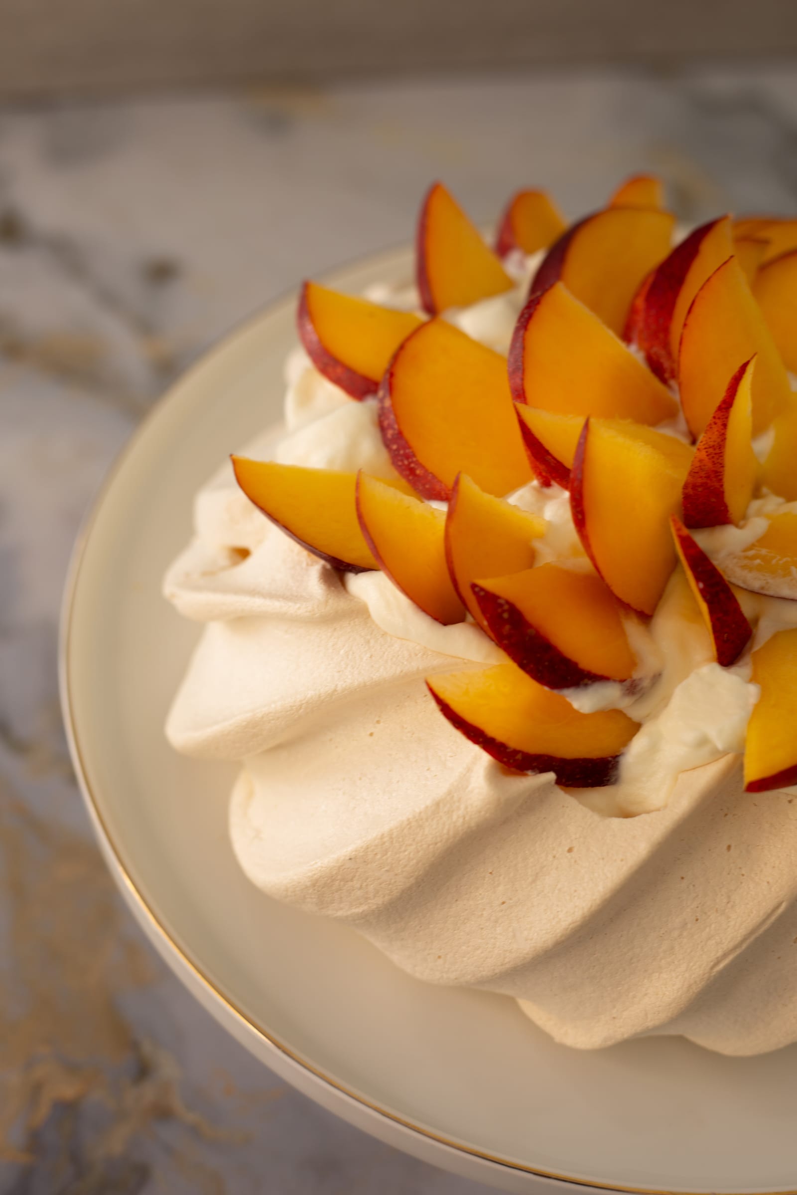 Fanned nectarine slices on the whipped cream, close up