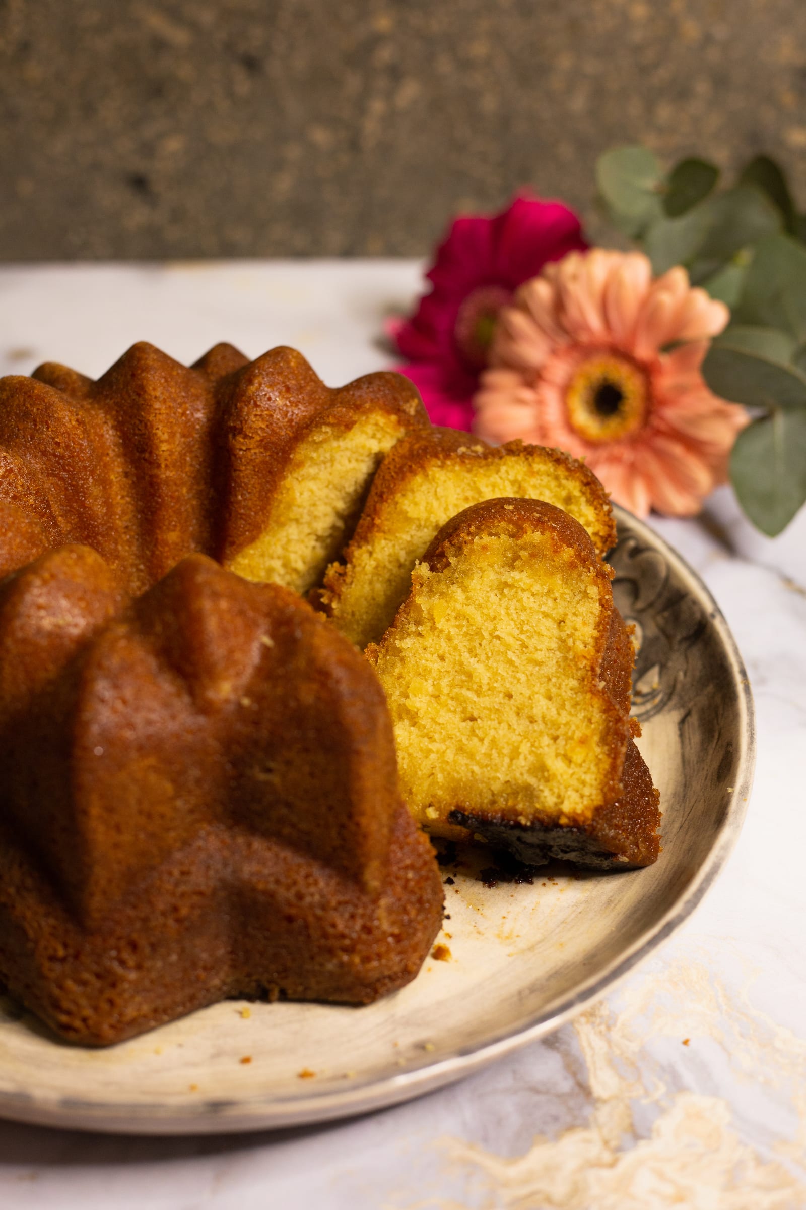 A sliced Kentucky butter cake on a plate against a dark background