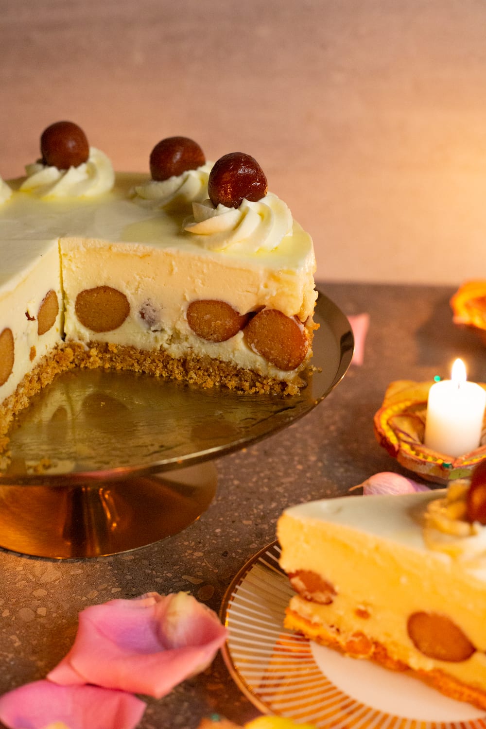 A slice of gulab jamun cheesecake on a plate