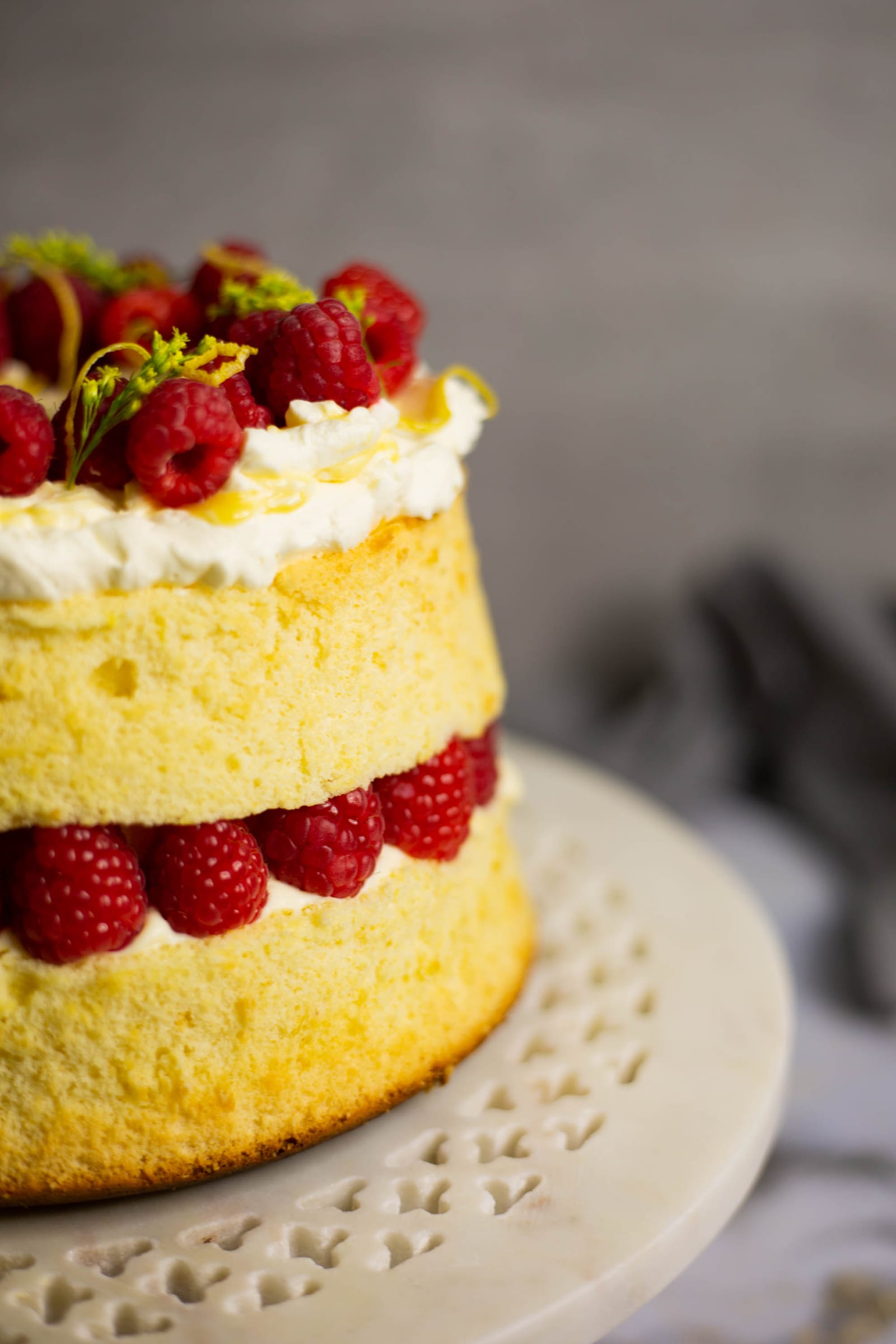 Close-up of cream, lemon curd and raspberries between the layers of a chiffon cake