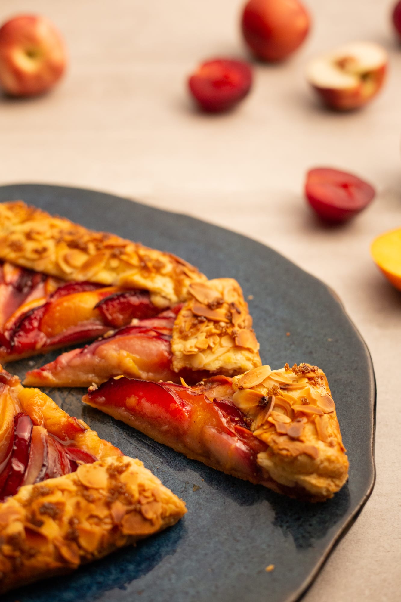A stone fruit galette with a wedge pulled out, from slightly above
