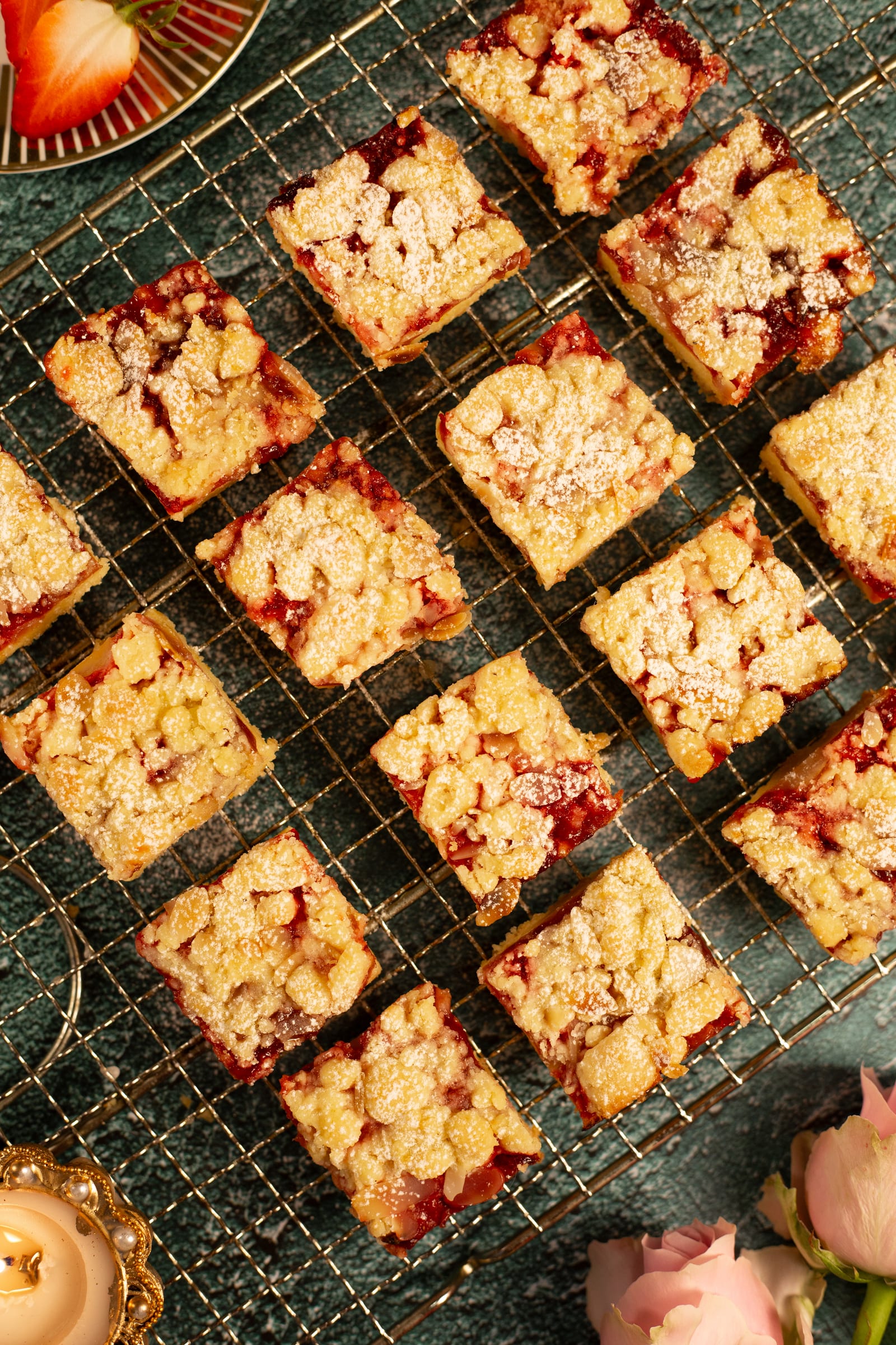 Squares of strawberry Hungarian tart on a wire rack, from above