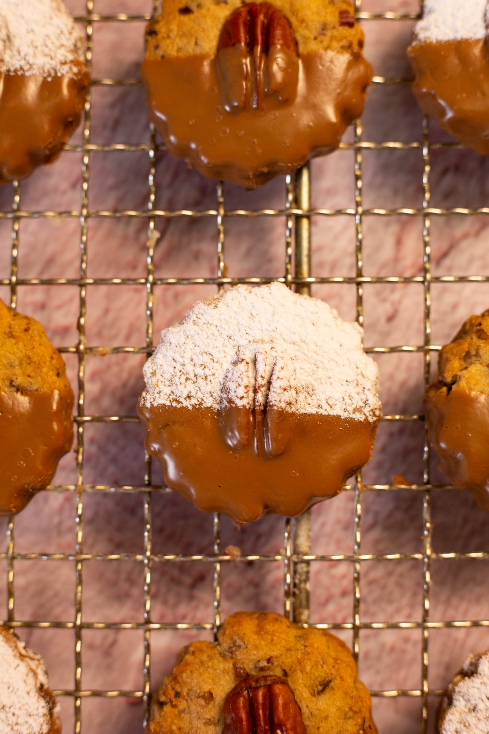 Biscuits dusted with icing sugar on one side and dipped in chocolate on the other