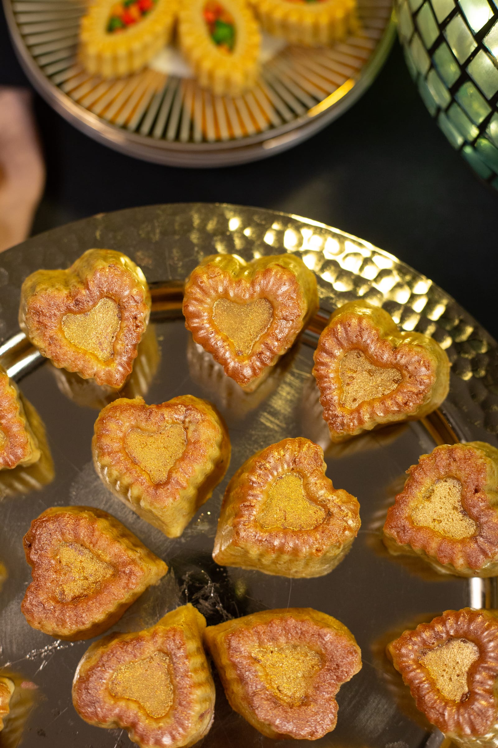 Heart-shaped channa magaj on a hammered gold plate, from above