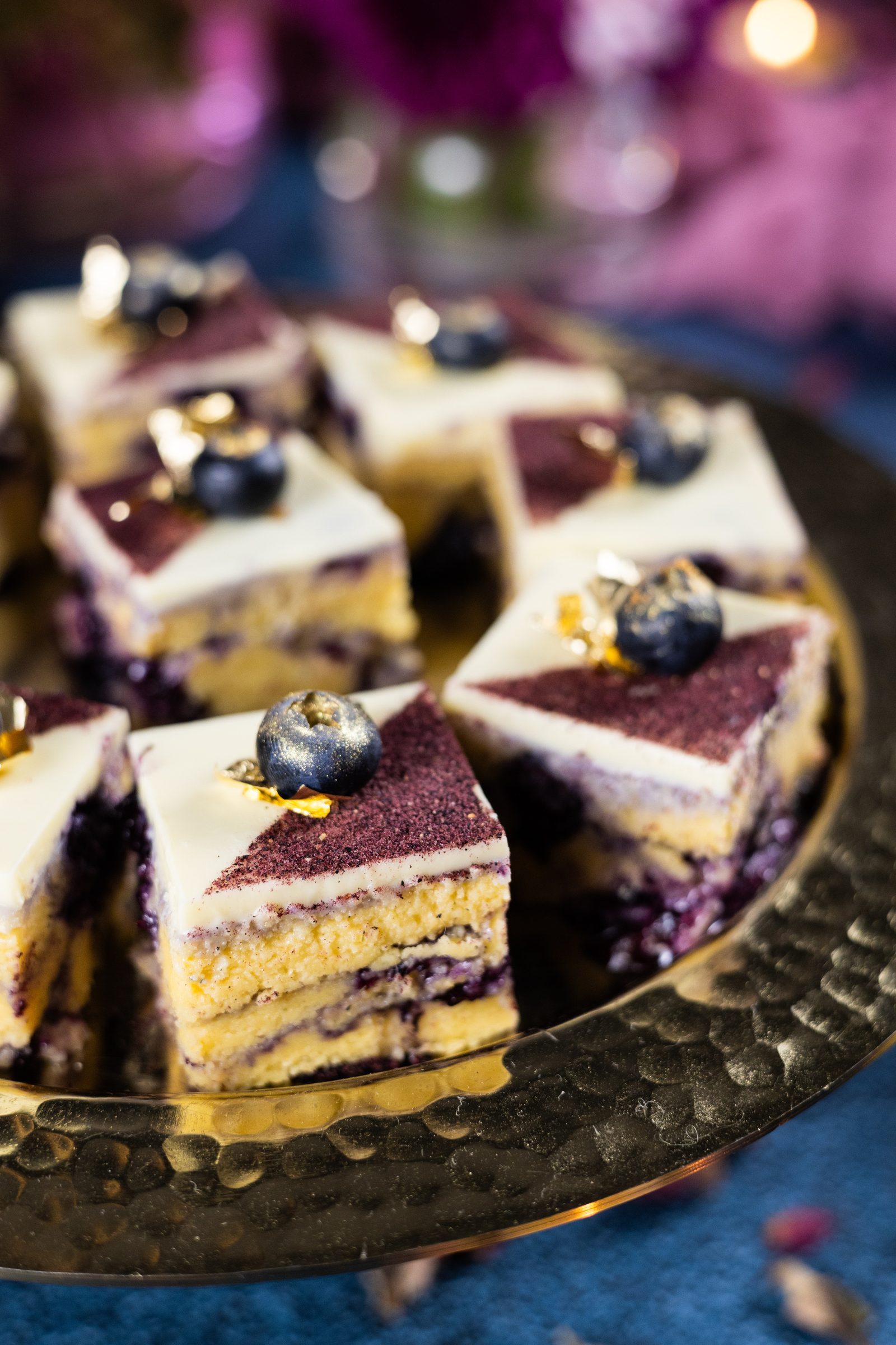 Close-up of blueberry ripple burfee from the side, showing the blueberry swirl under the white chocolate