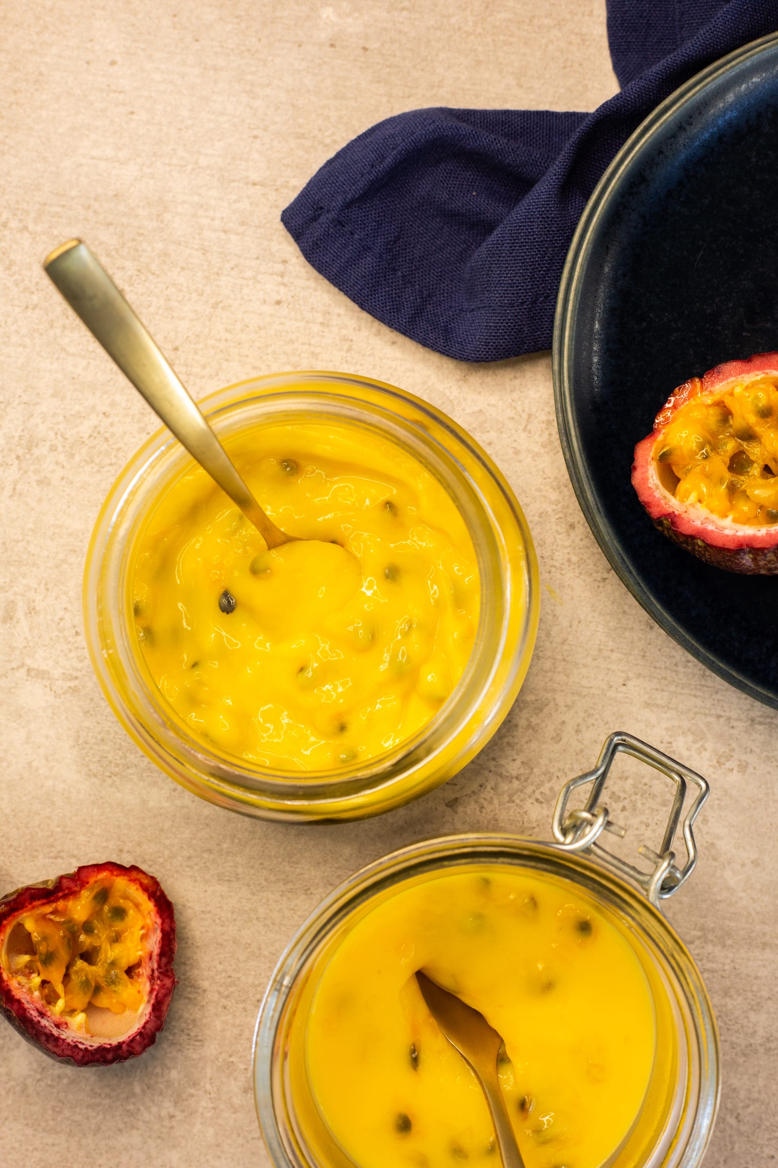 Passionfruit curd in open jars, from above
