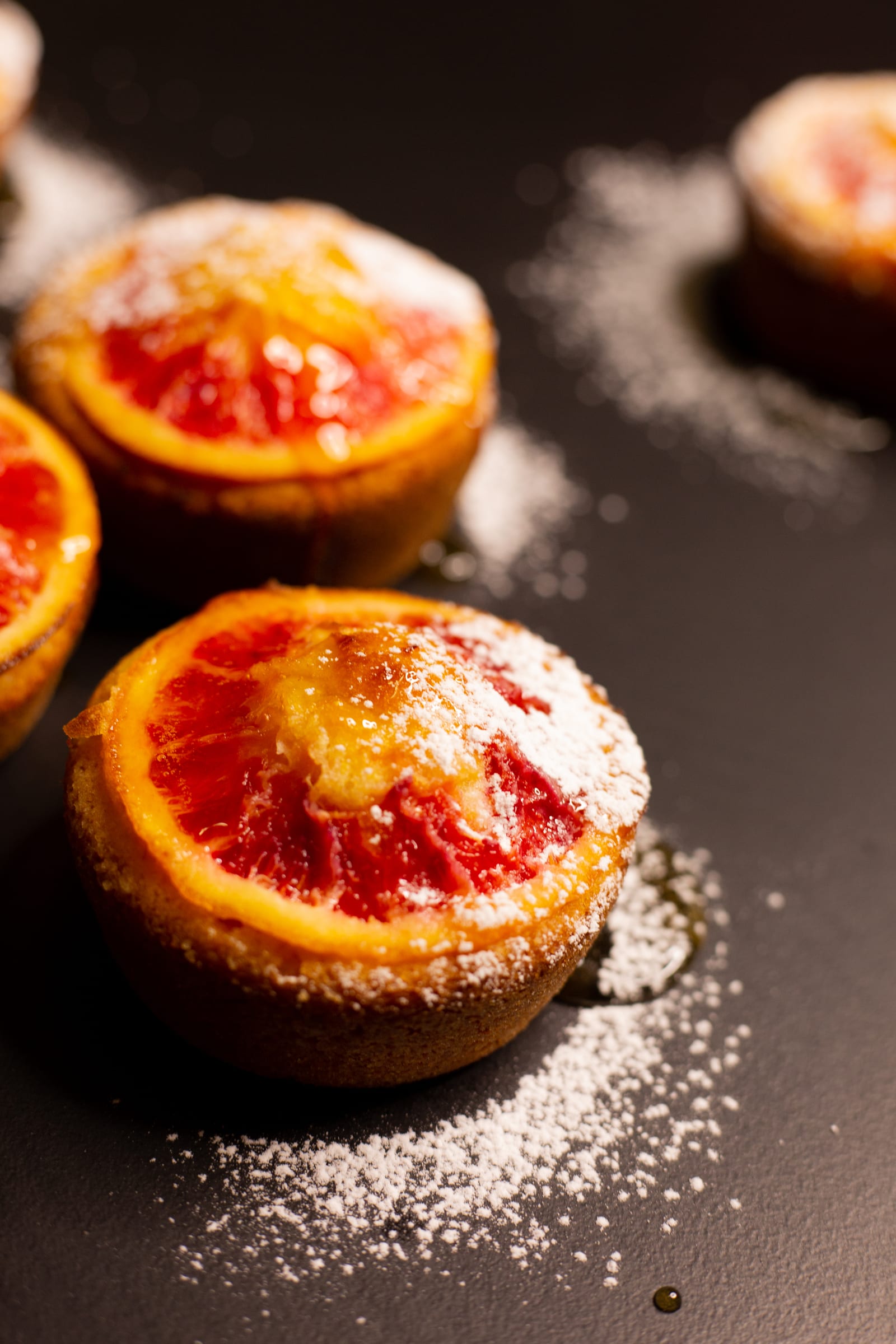 Close-up of an almond, semolina and blood orange syrup cake topped with a sugared orange slice