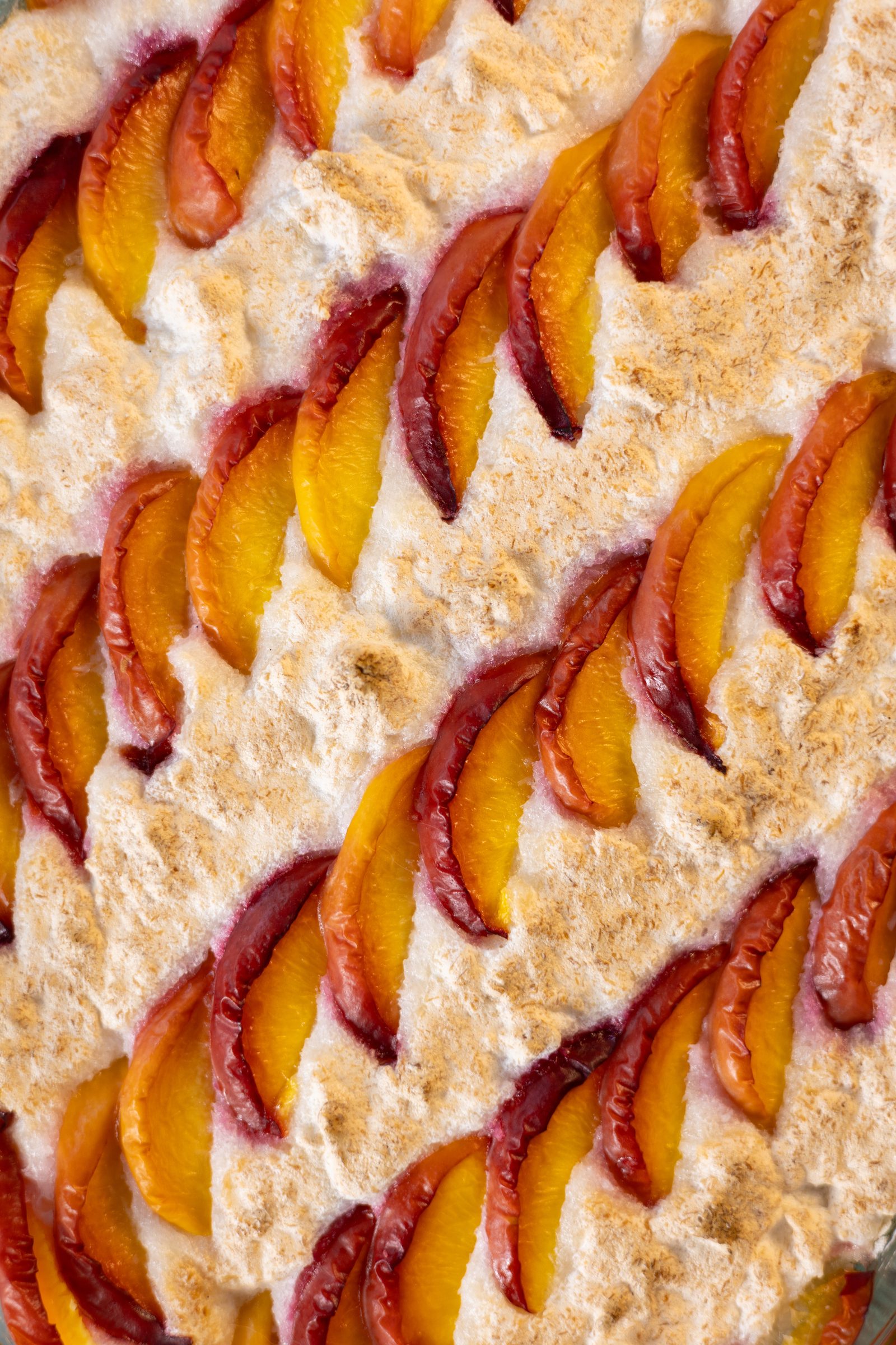 A close-up of the tanned coconut meringue and nectarine wedges
