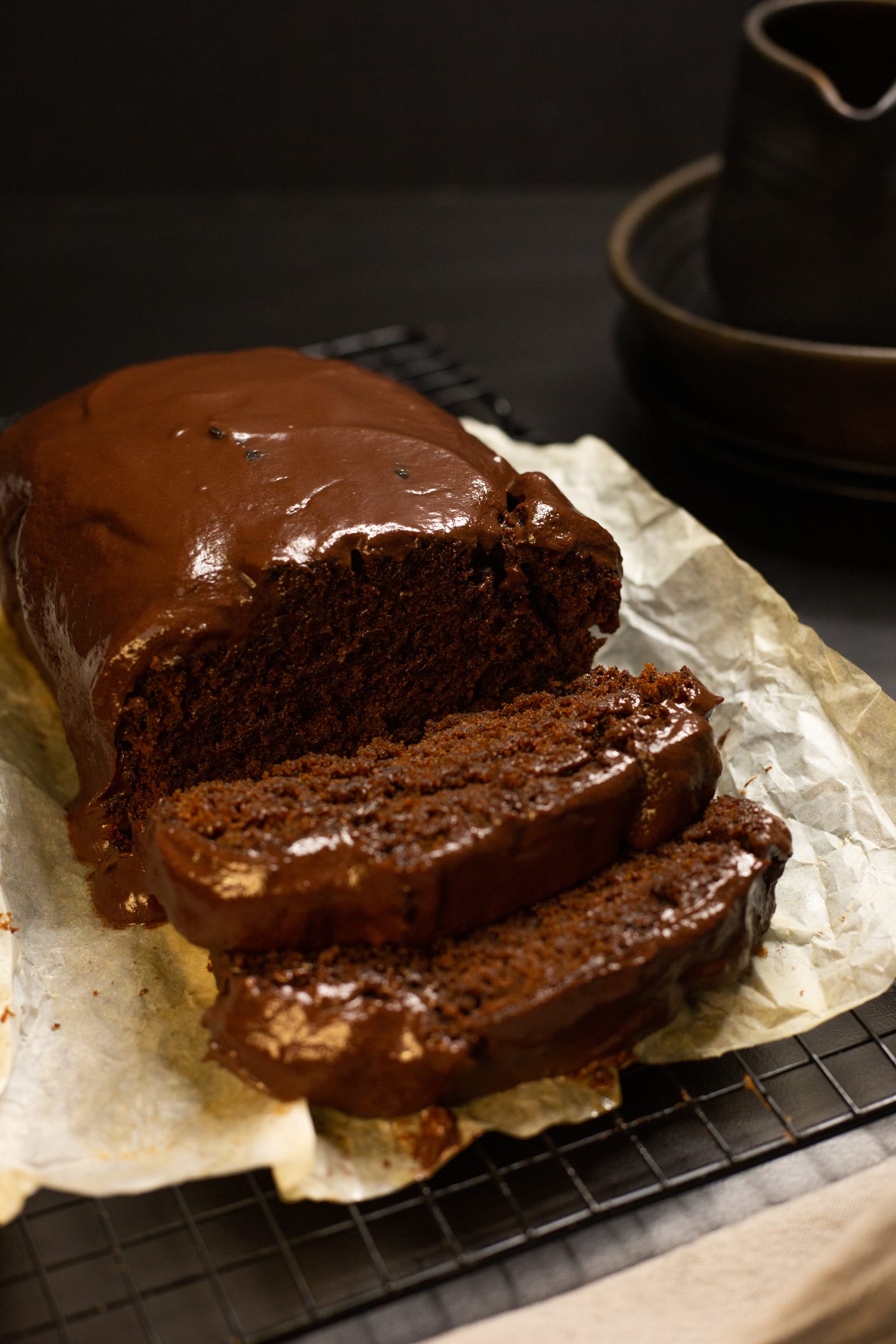 Thick slices cut from the ganache-topped chocolate banana bread
