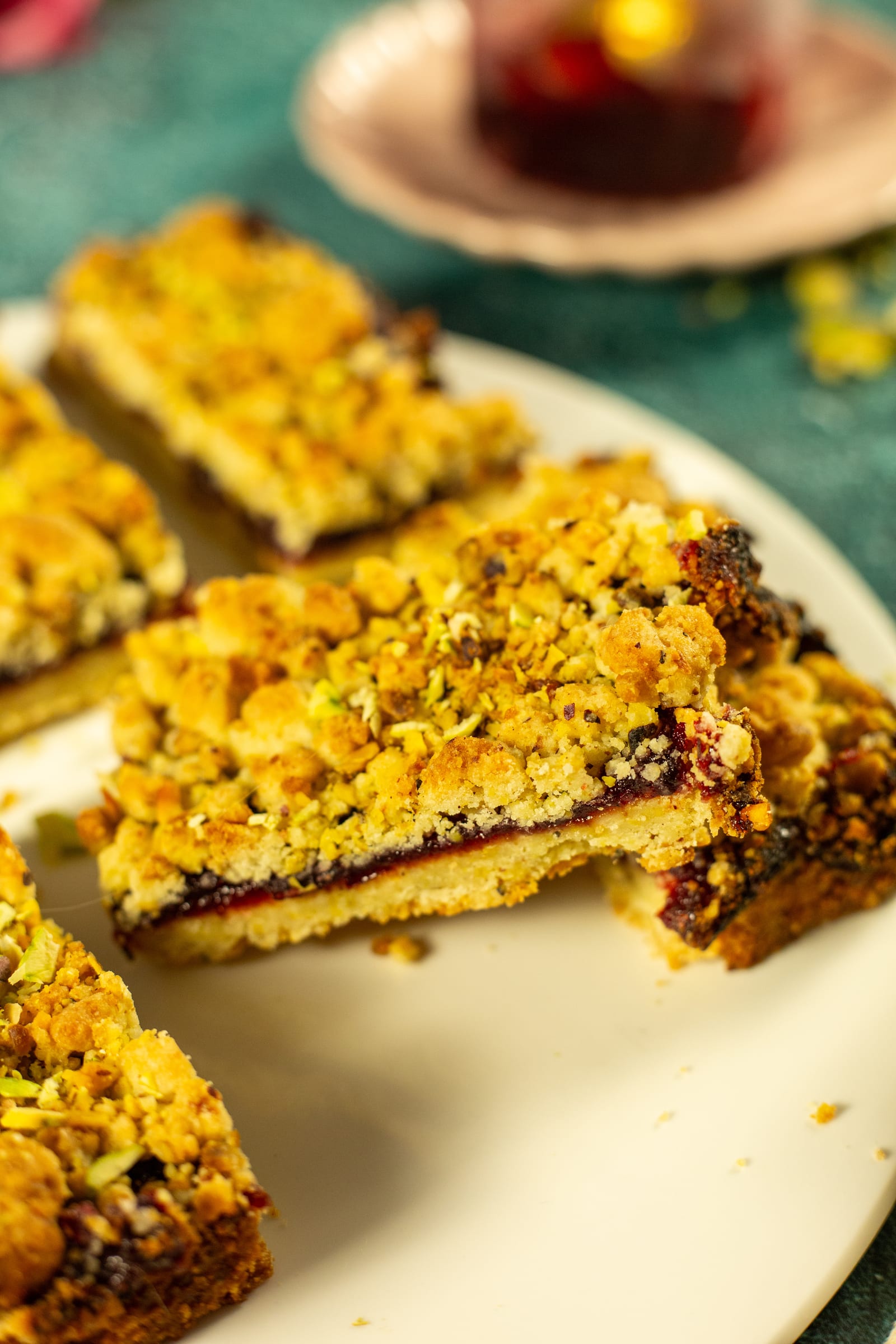 Stacked Hungarian tart bars, showing the plum jam between shortbread and crumble