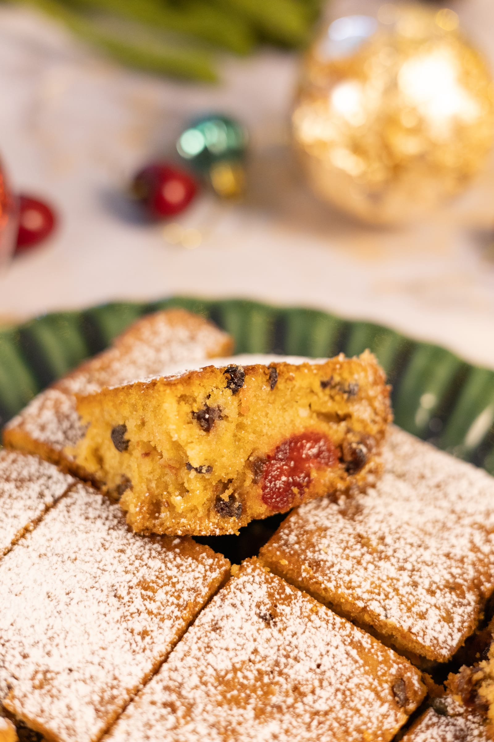 Close-up of a cut piece of fruitcake showing the fruit inside