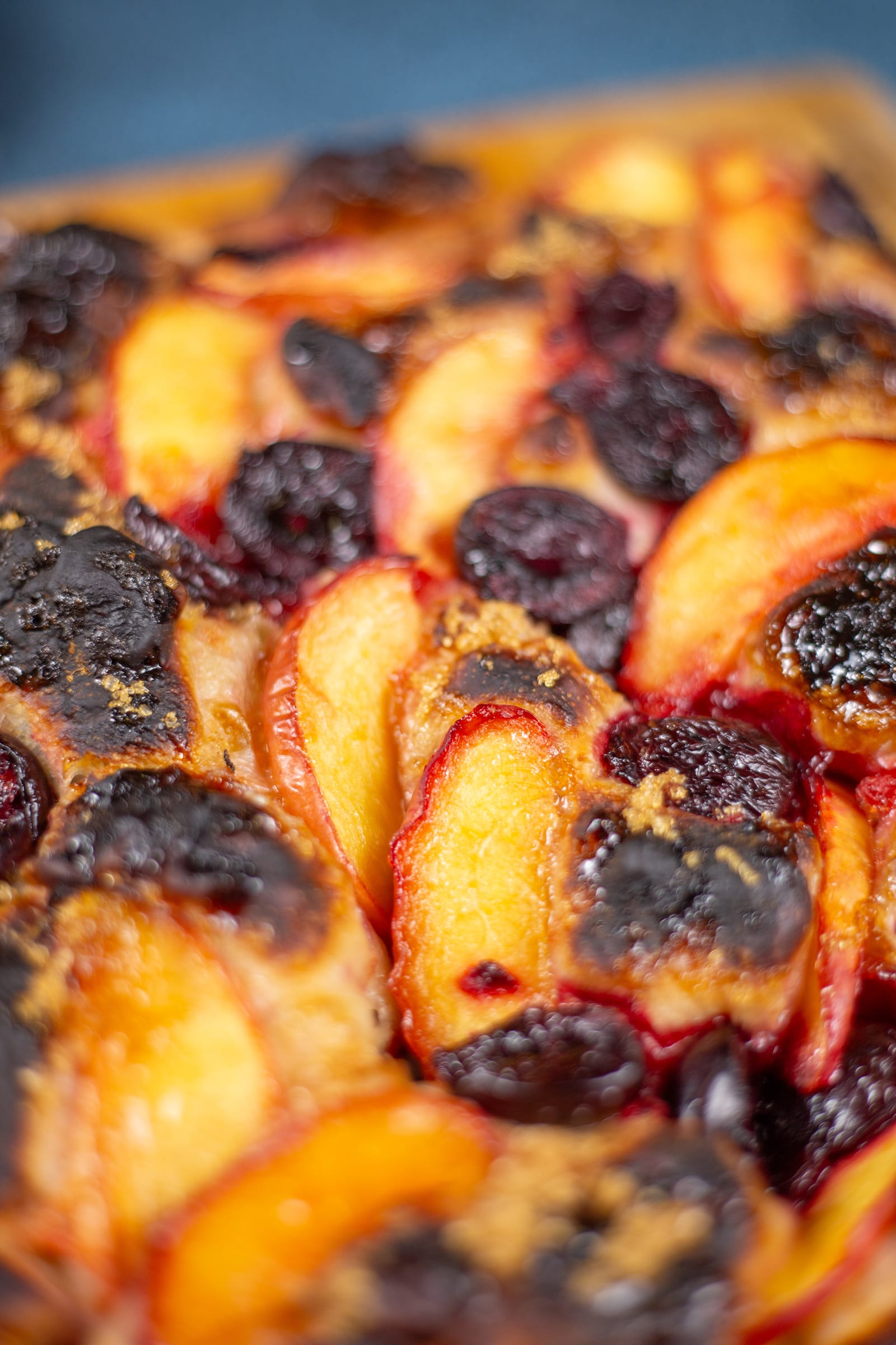Close-up of caramelised nectarines and cherries on the focaccia