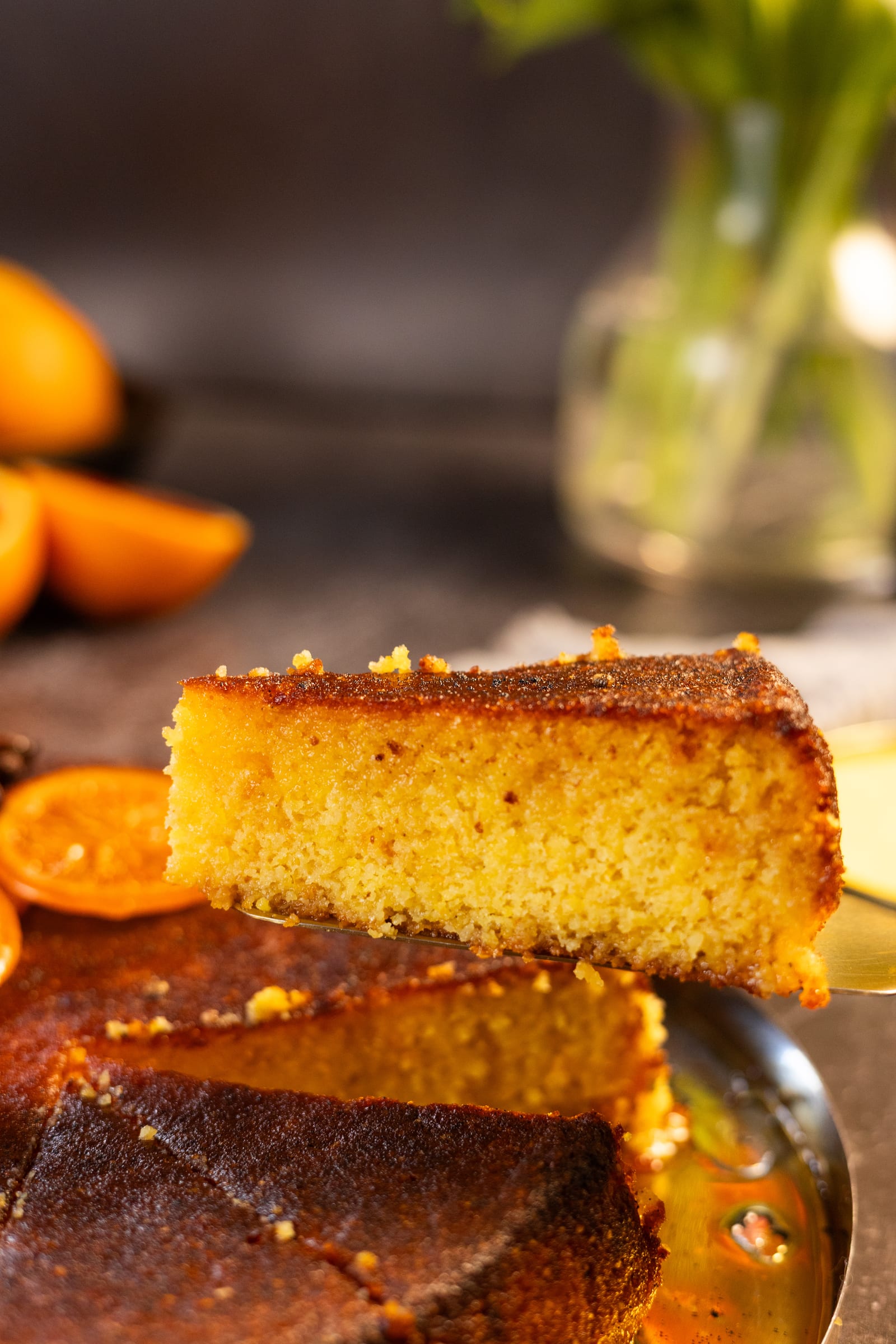 A slice lifted from the cake, showing its golden polenta crumb