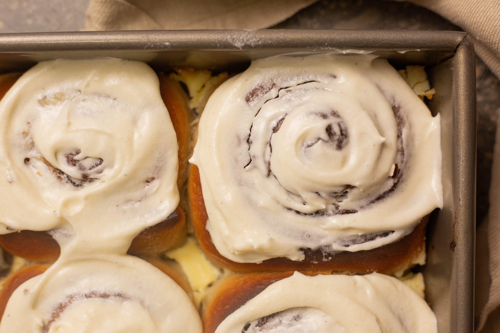 Cinnamon rolls generously topped with cream cheese icing