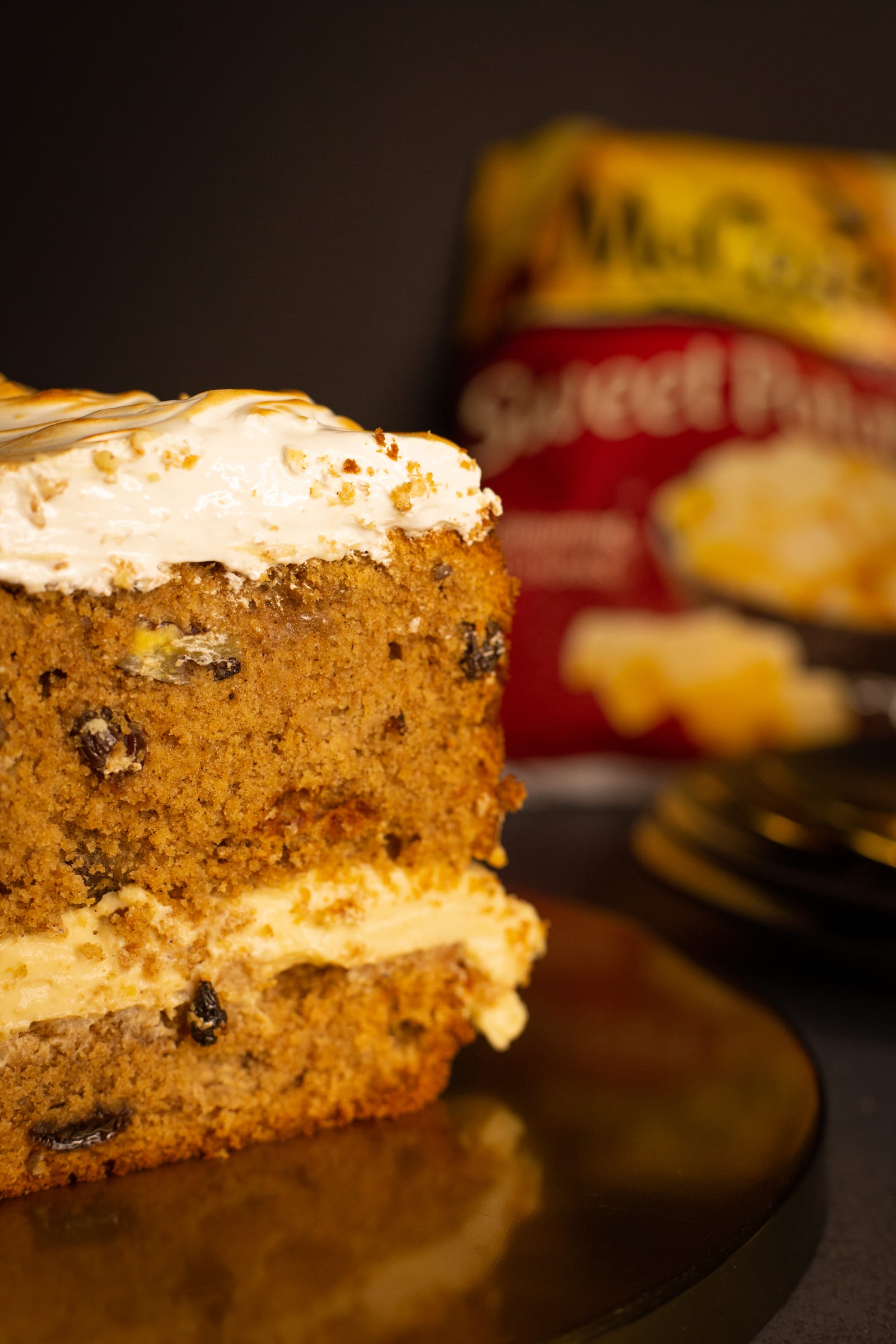 Close-up of the cut face of a sweet potato loaf, showing the crumb and the brown butter maple frosting