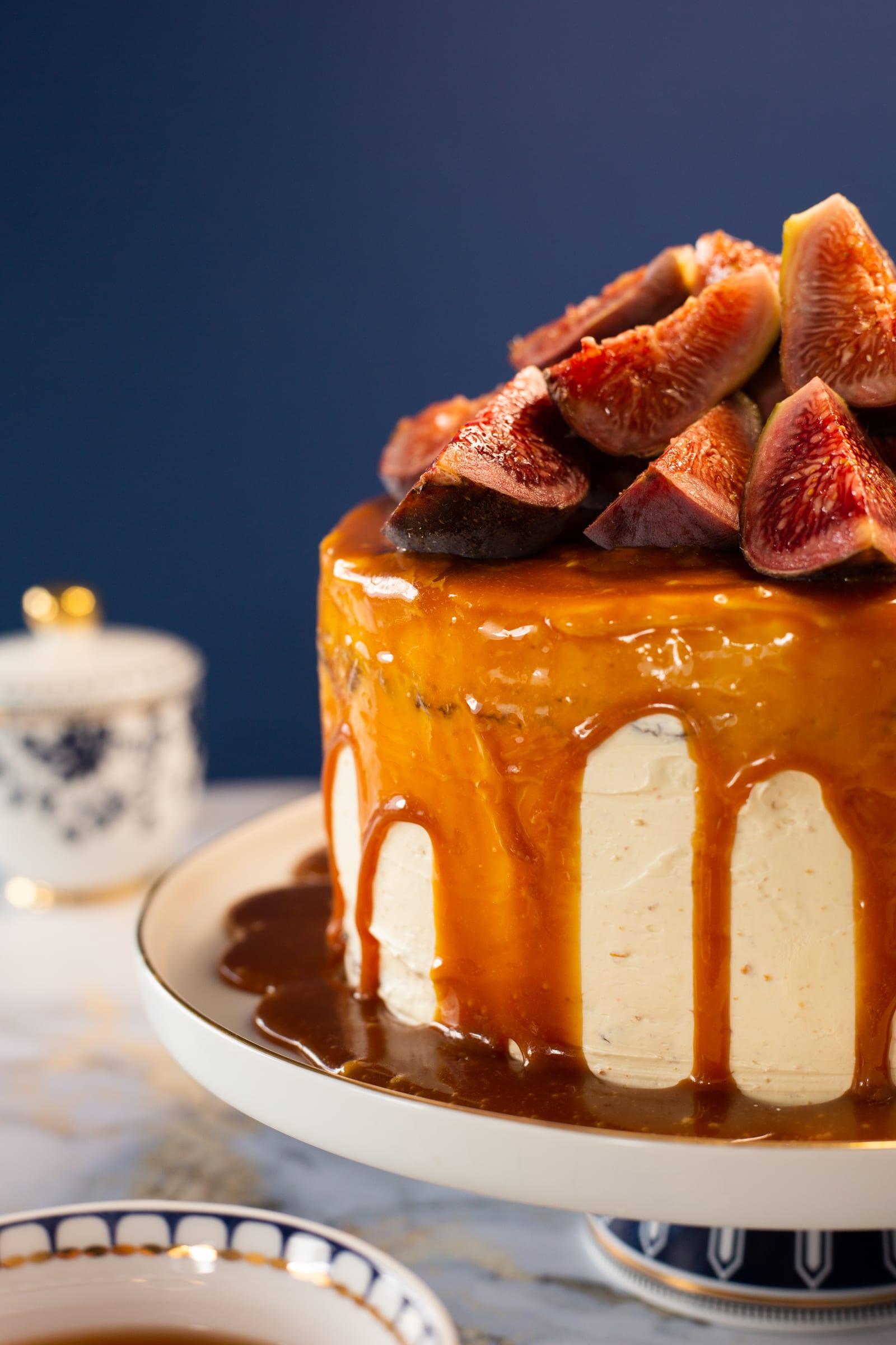 Caramel dripping down the hazelnut buttercream under a crown of halved fresh figs