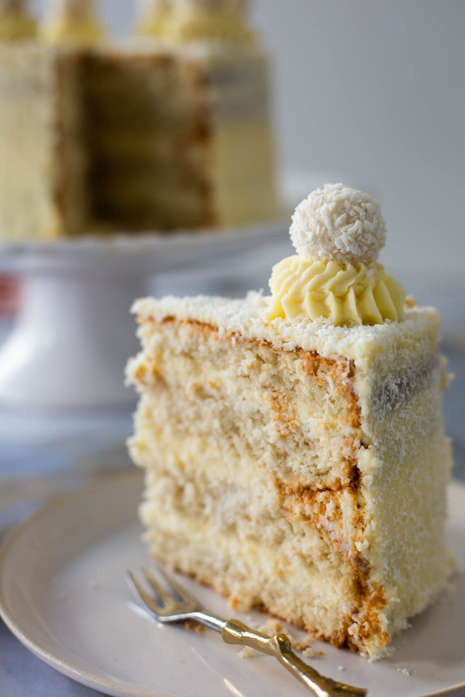Close-up of the layers in a slice of Raffaello cake, the cake blurred behind