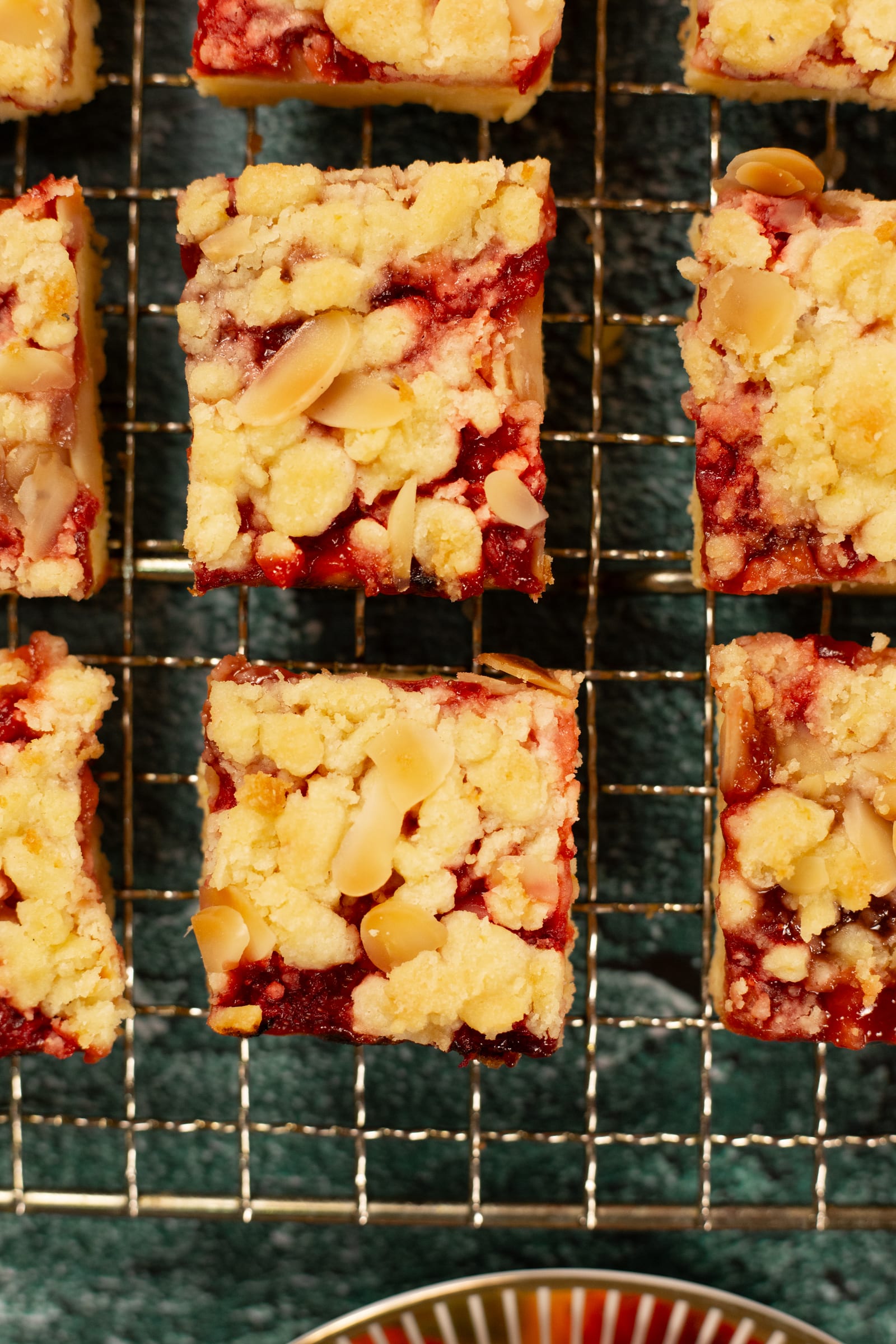 Close-up of crumble, almonds and strawberry jam on the tart