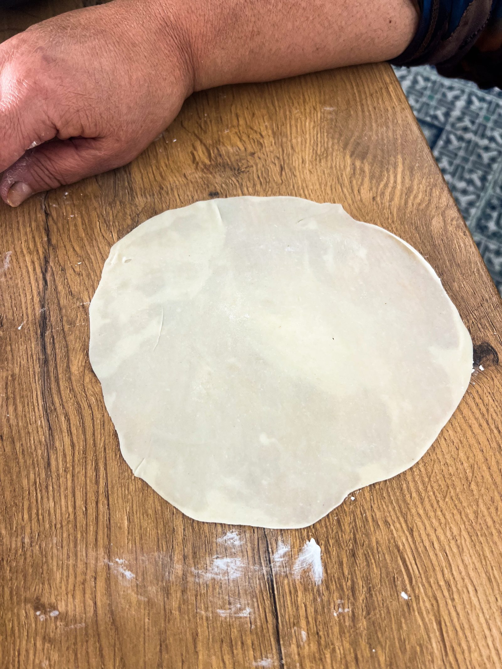 A thinly rolled mawa ghari casing on a floured wooden table