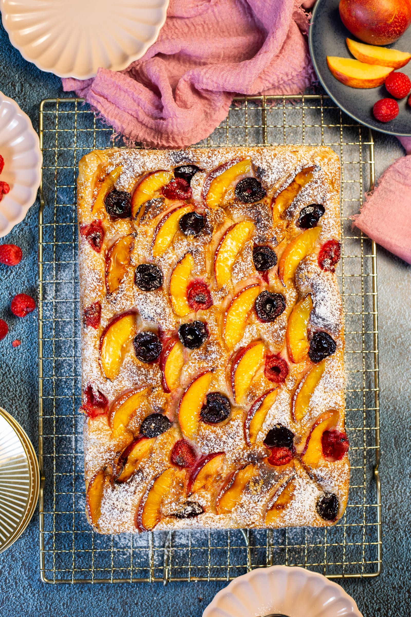 The whole nectarine and cherry focaccia on a rack, from above
