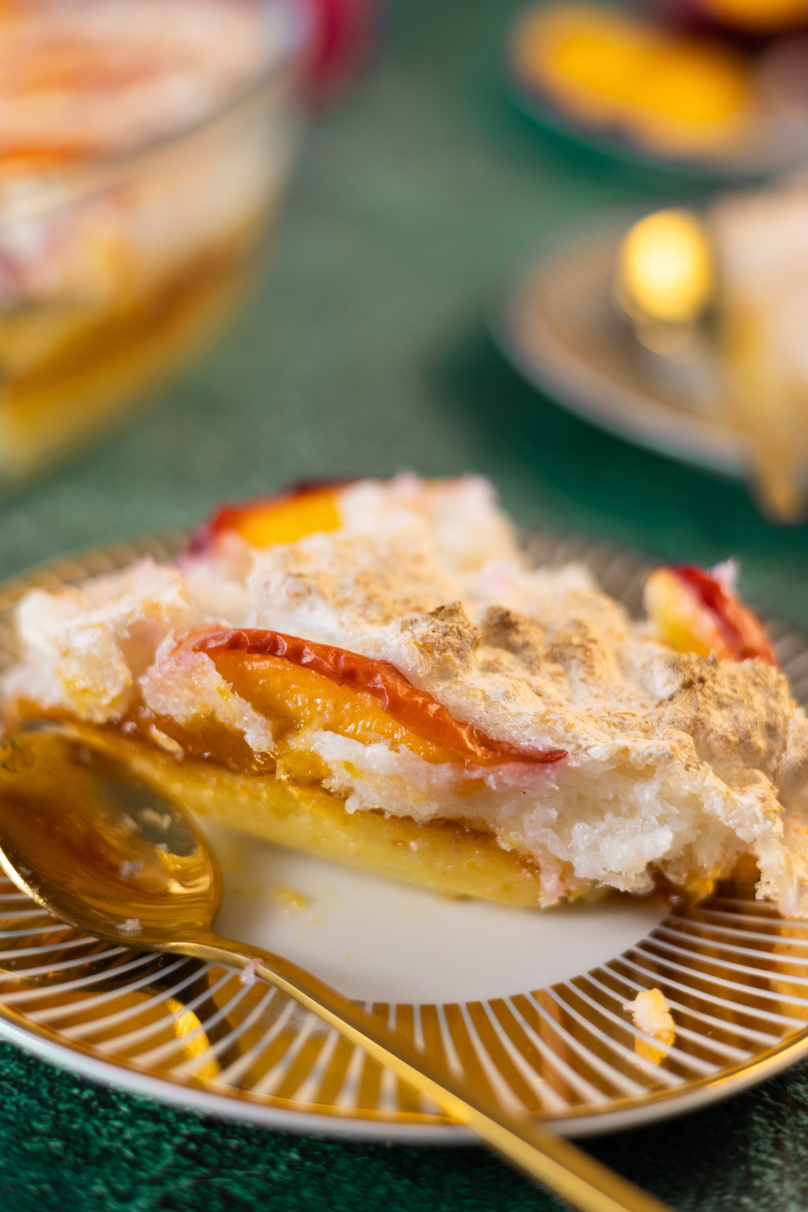 A slice of Fehmz coconut pudding from the side, showing the meringue, nectarine and pudding layers