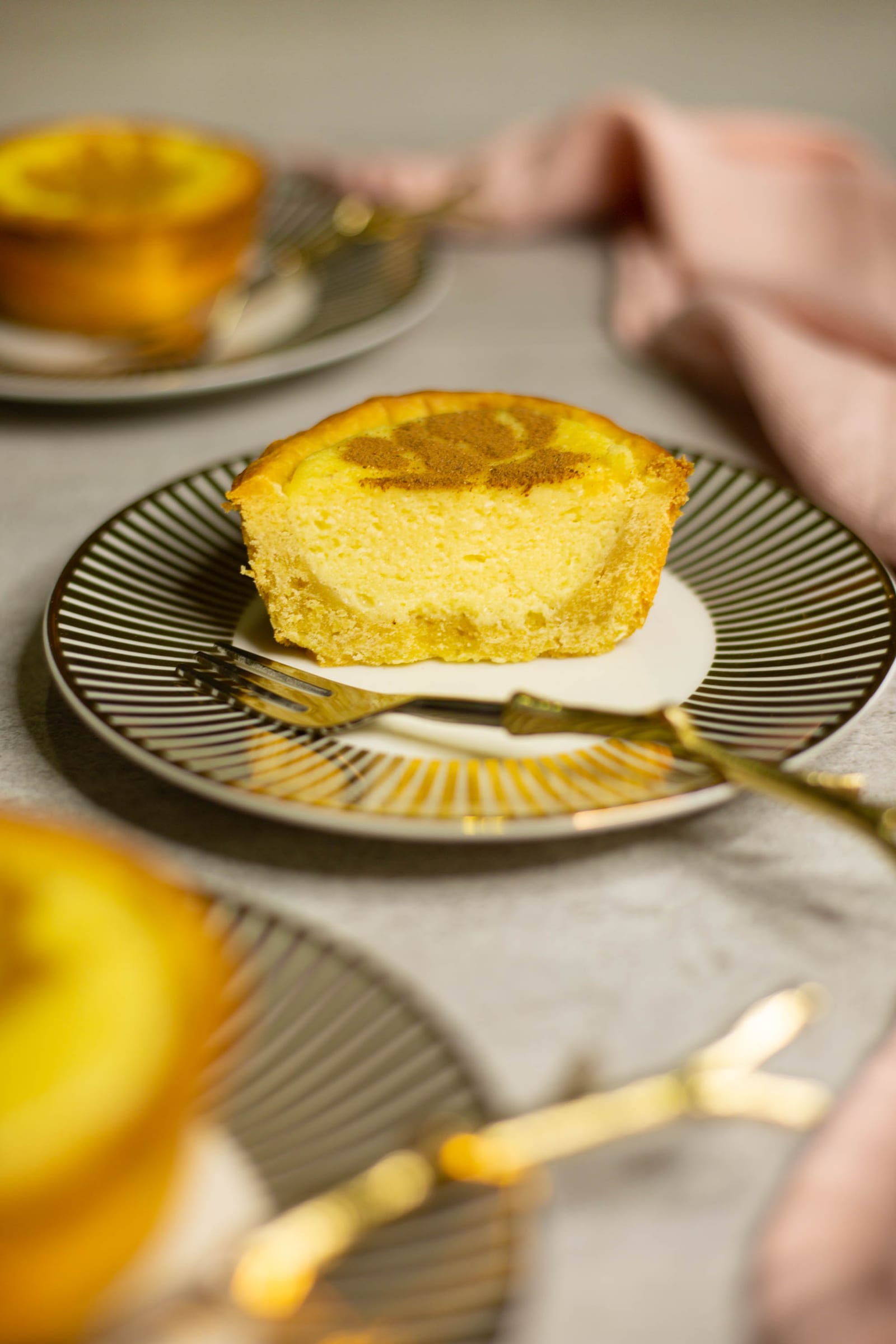 A mini milktart with a piece cut away, showing the custard inside