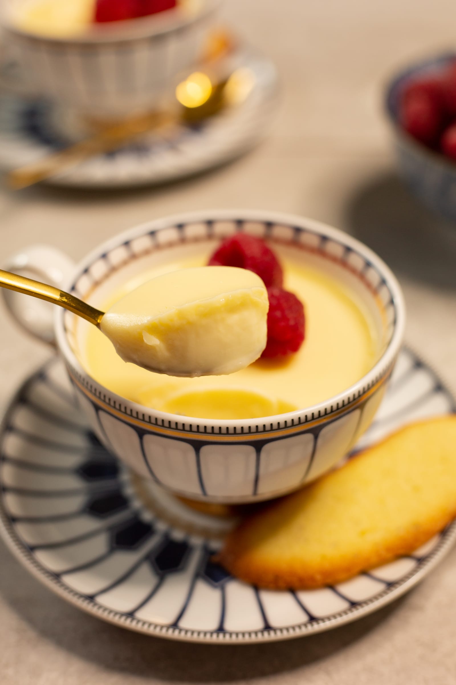 A spoonful of silky lemon posset lifted out of the cup