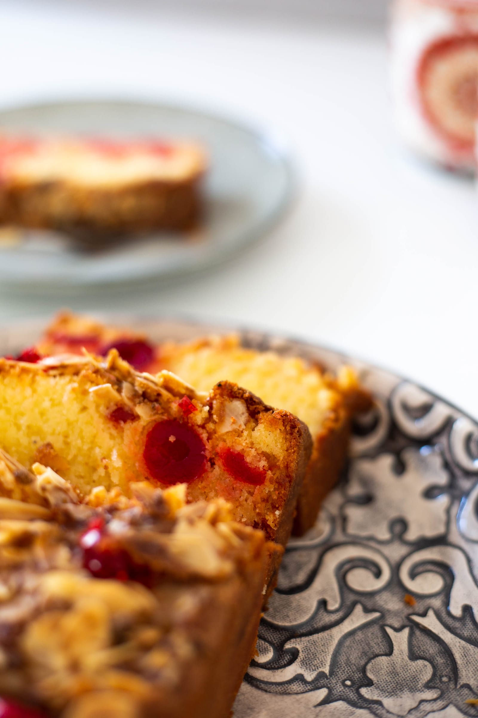 Slices of gluten-free cherry and almond loaf showing the cherry-studded crumb