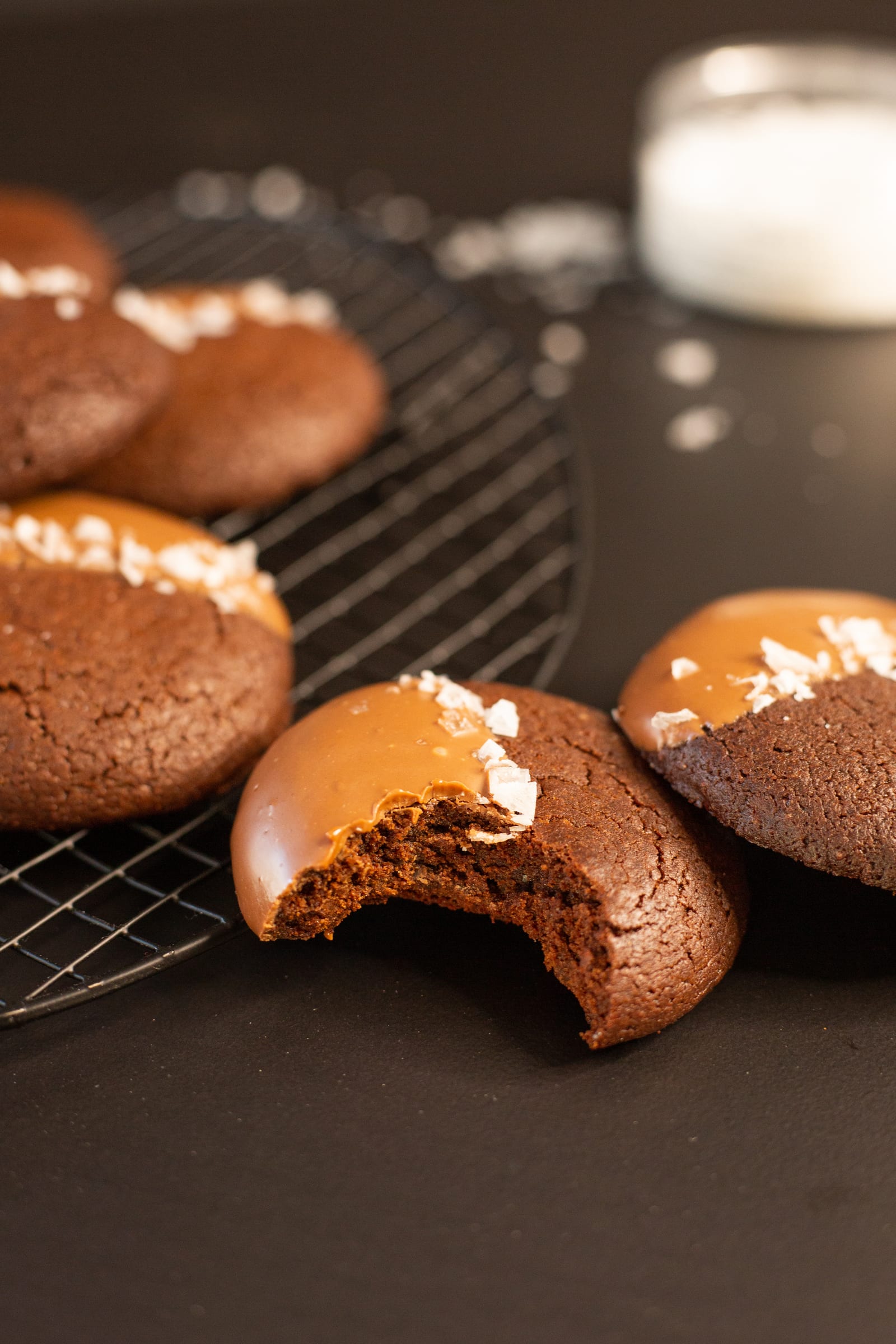 A bitten rye brownie cookie showing its chewy, fudgy middle