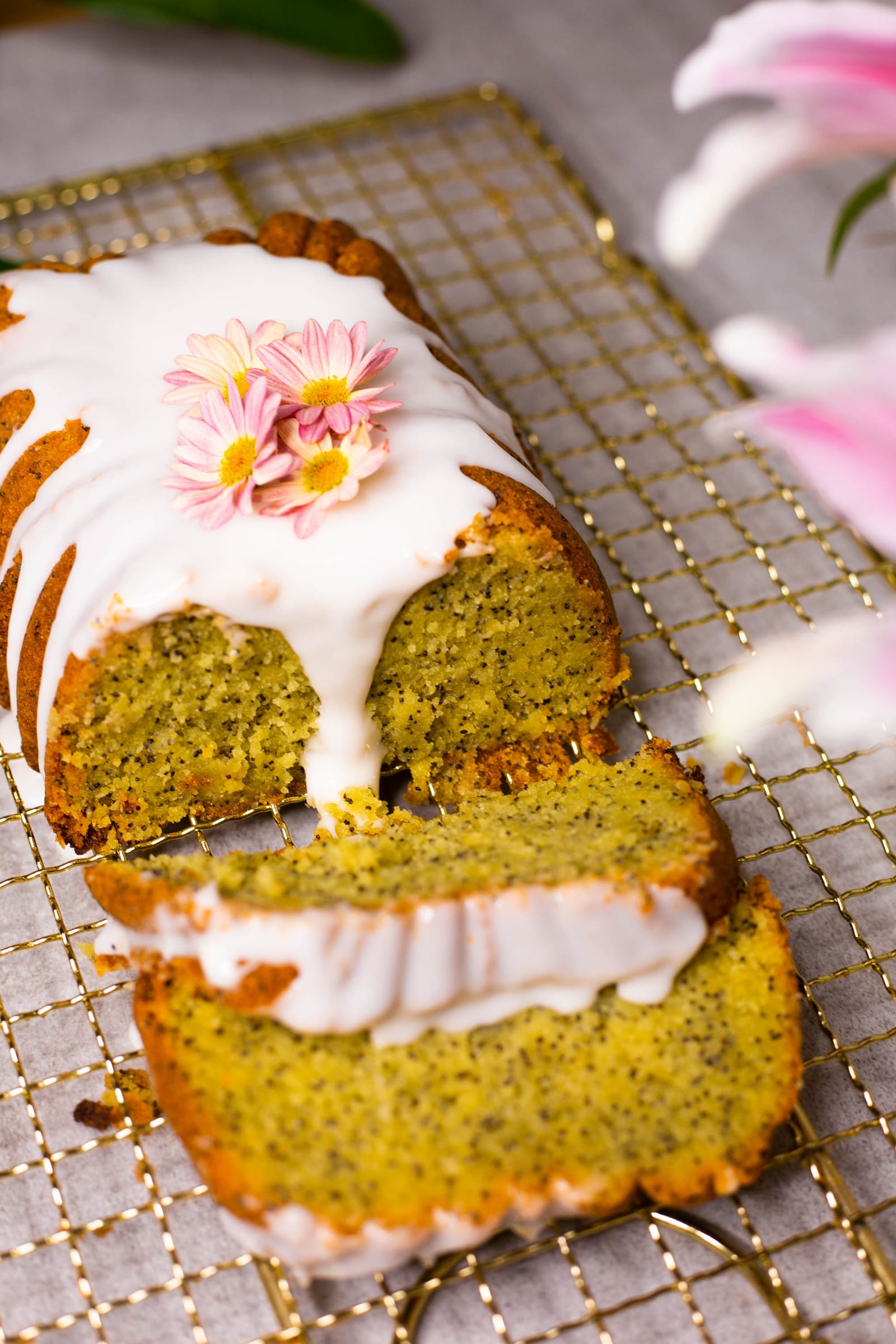 Close-up of slices of gluten-free lemon and poppyseed loaf, showing the glaze and crumb