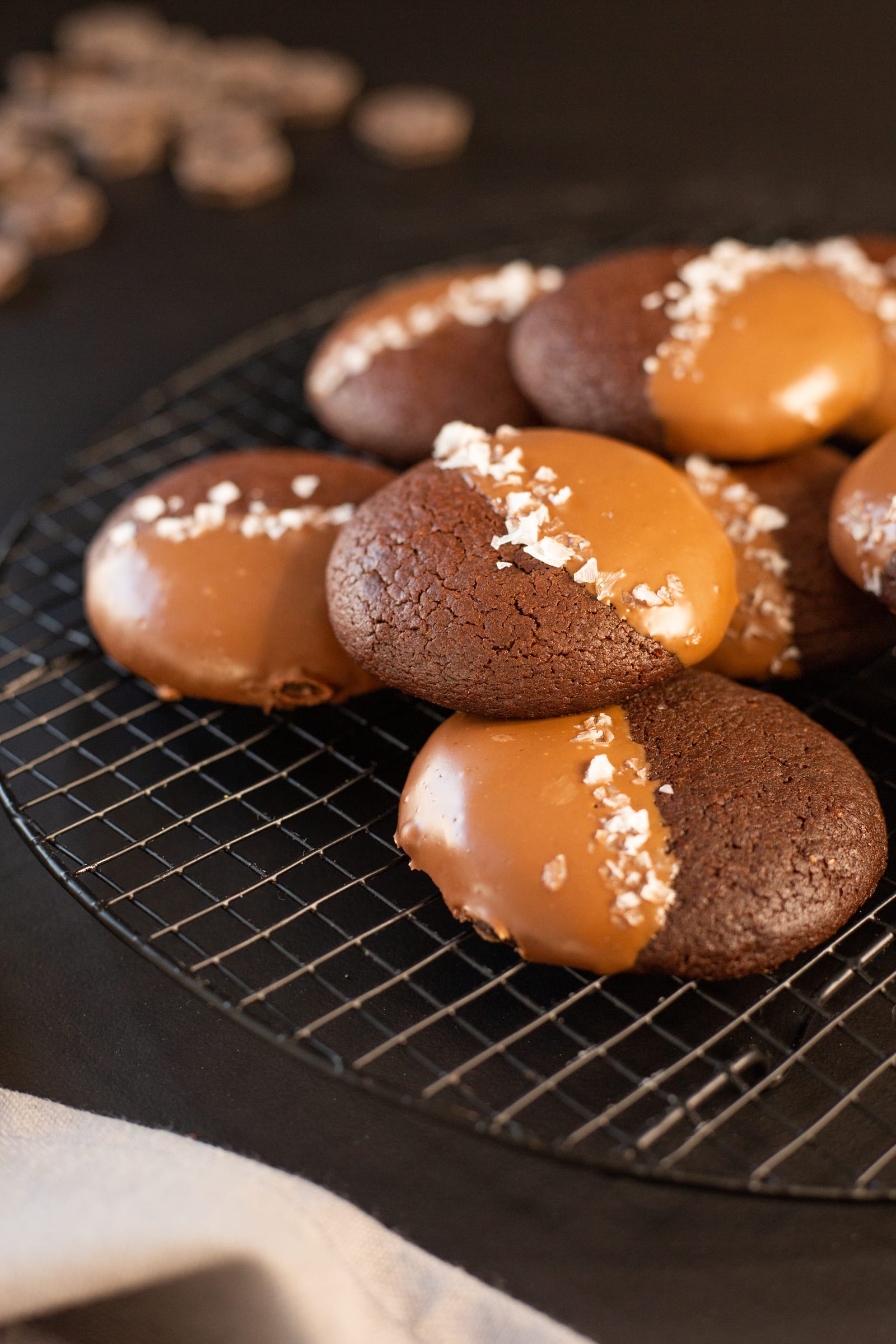 Rye brownie cookies piled on a cooling rack