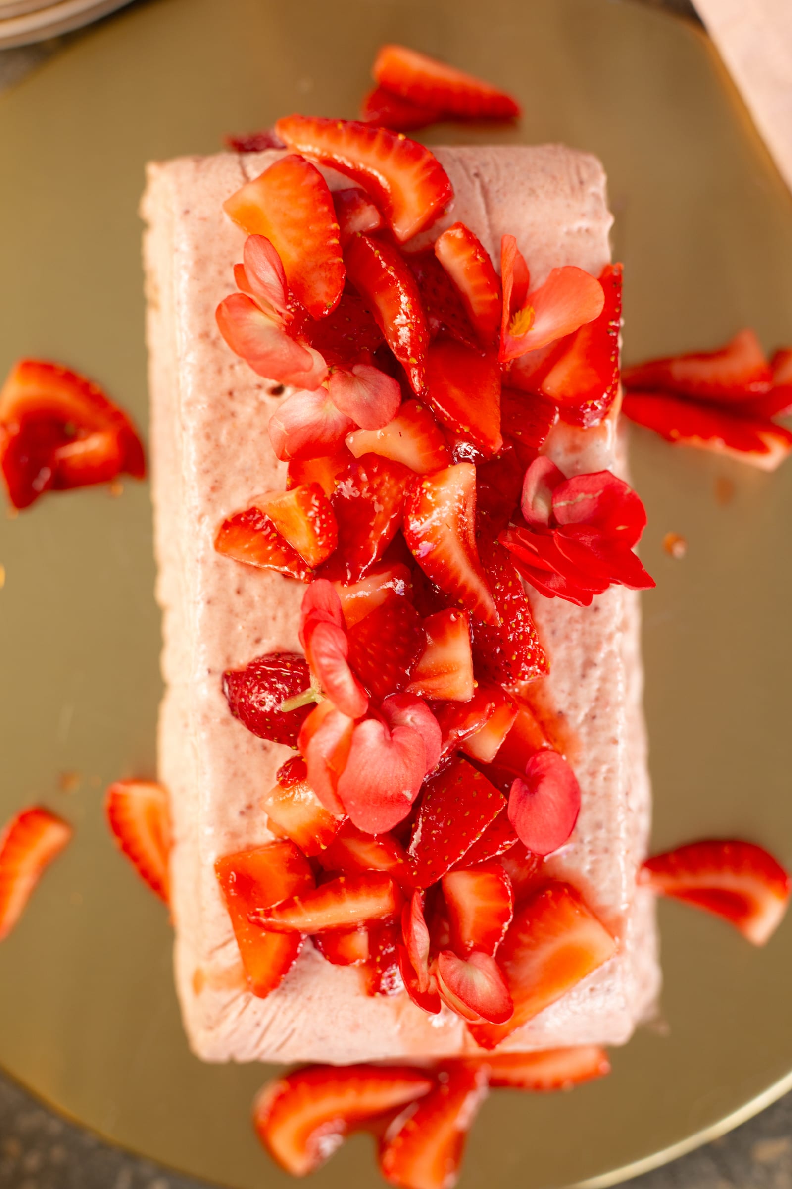 The top of a roasted strawberry and rosemary semifreddo from above, covered in roasted strawberries