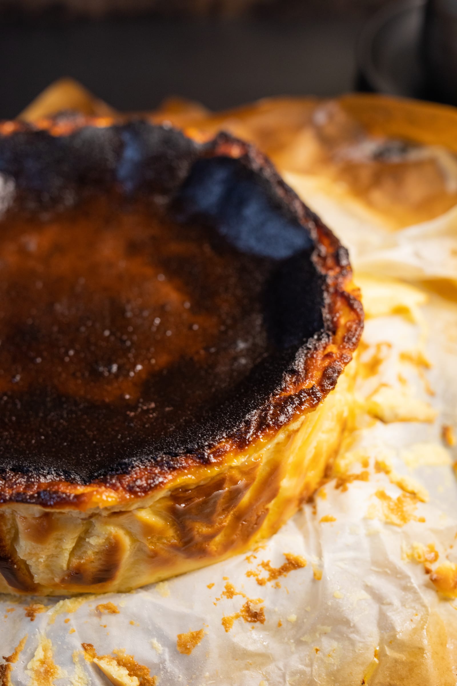 The dark caramelised top and scorched edge of a Basque cheesecake