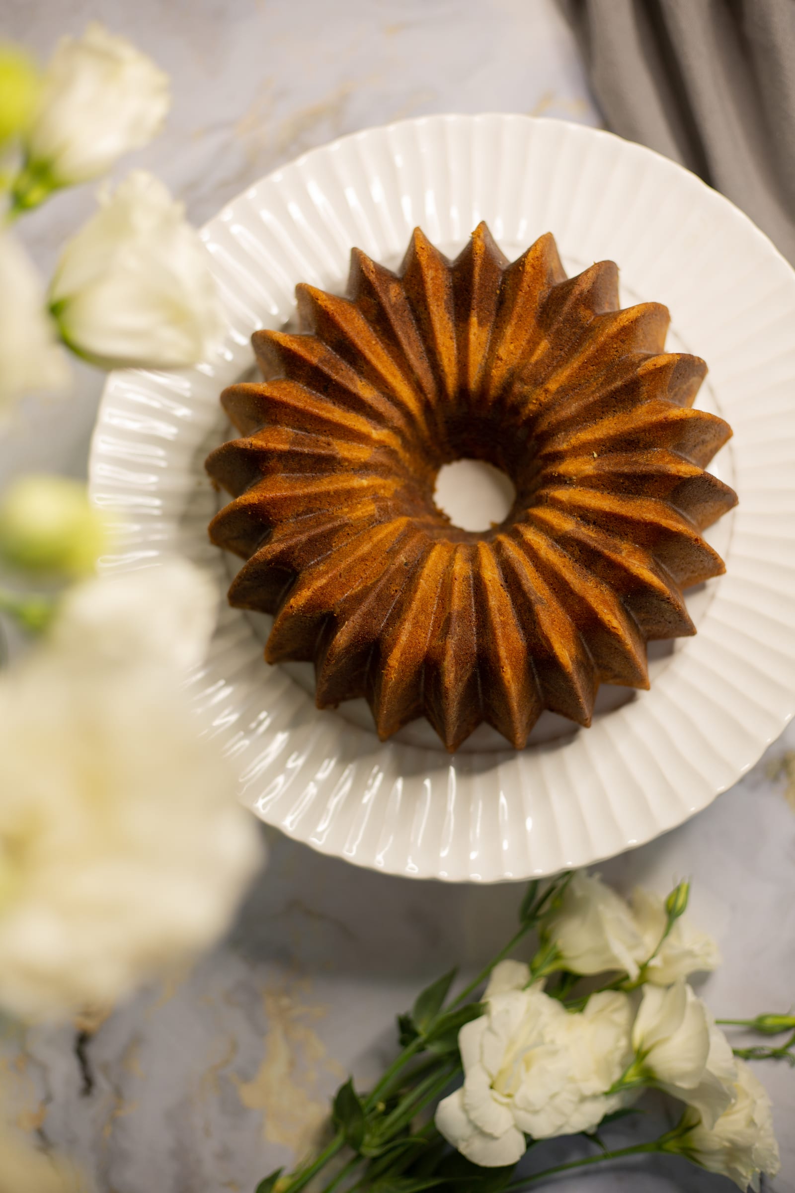 The fluted marble pound cake on a white plate, from above
