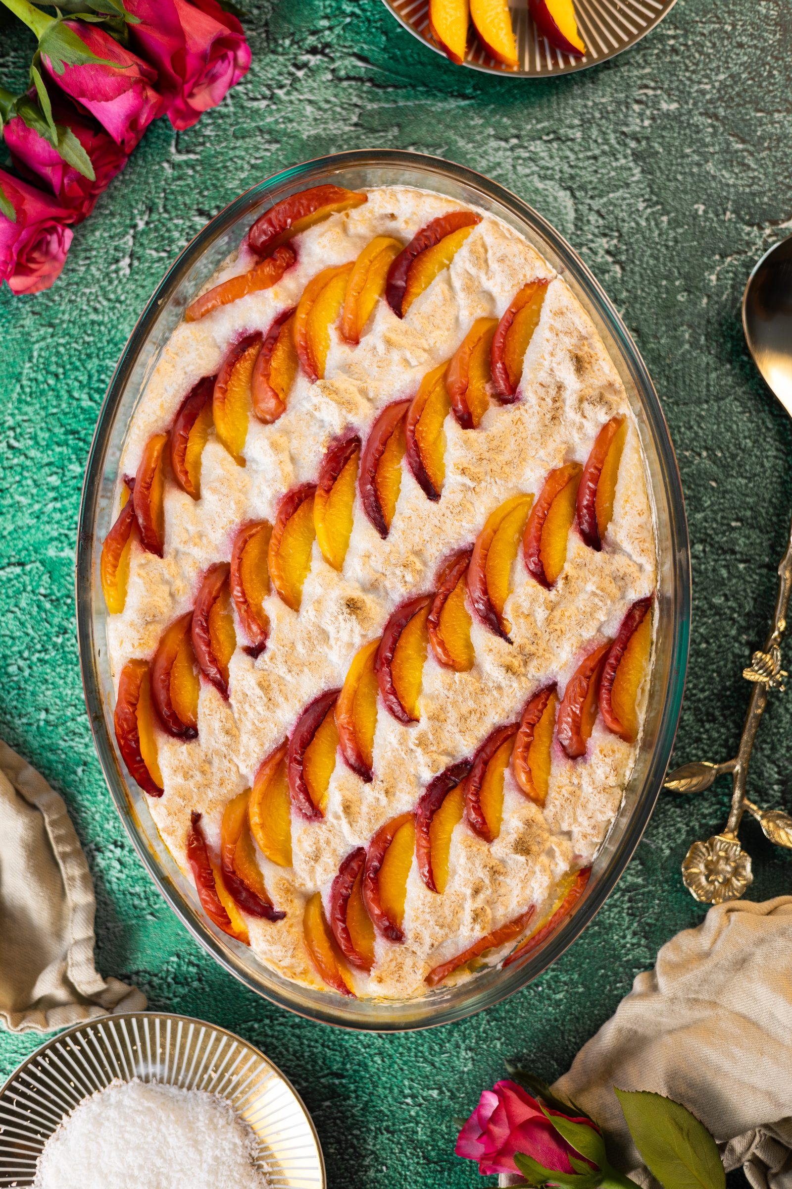 The whole Fehmz coconut pudding from above, its meringue lined with rows of nectarine slices