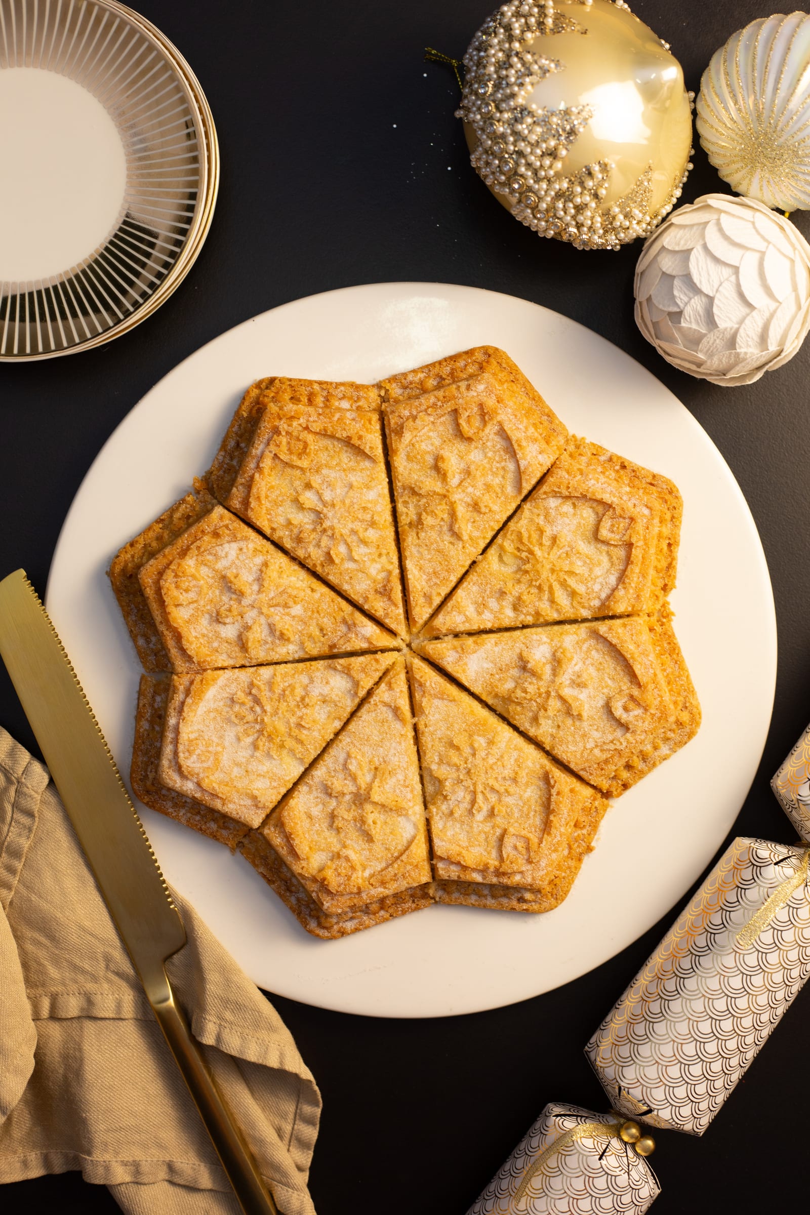Star-shaped shortbread on a white plate, from above
