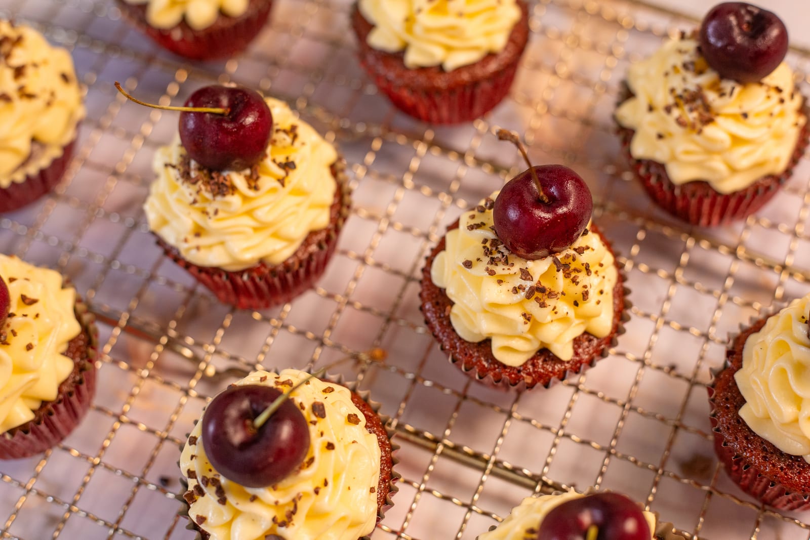 Red velvet cupcakes on a wire rack, from above