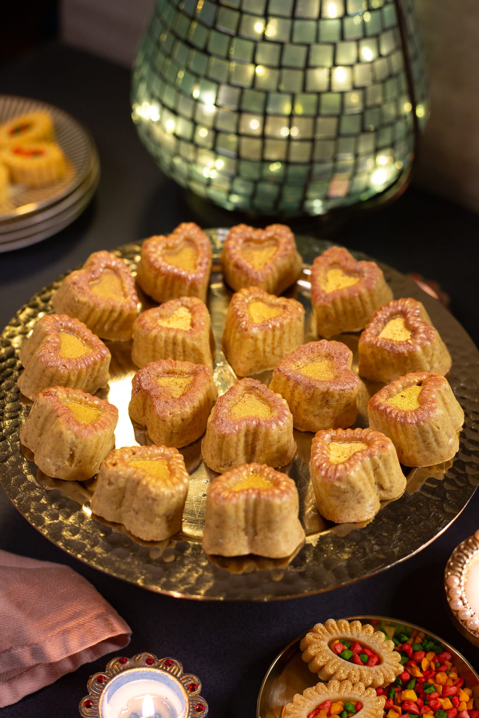 A plate of channa magaj hearts with a glowing lantern behind