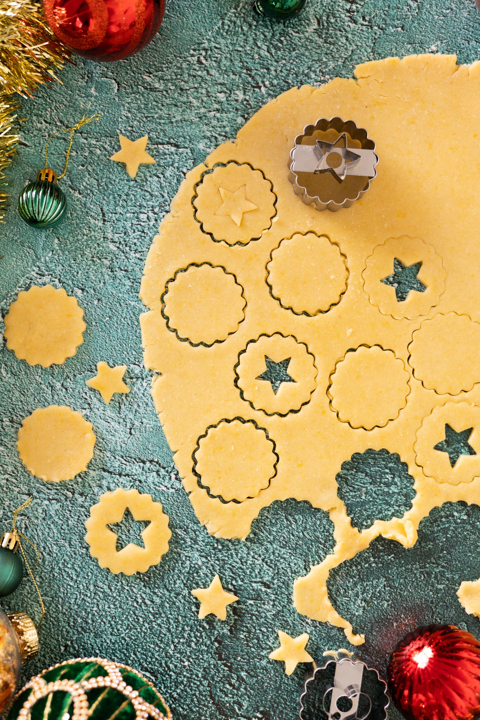 Rolled pastry being cut into circles and stars