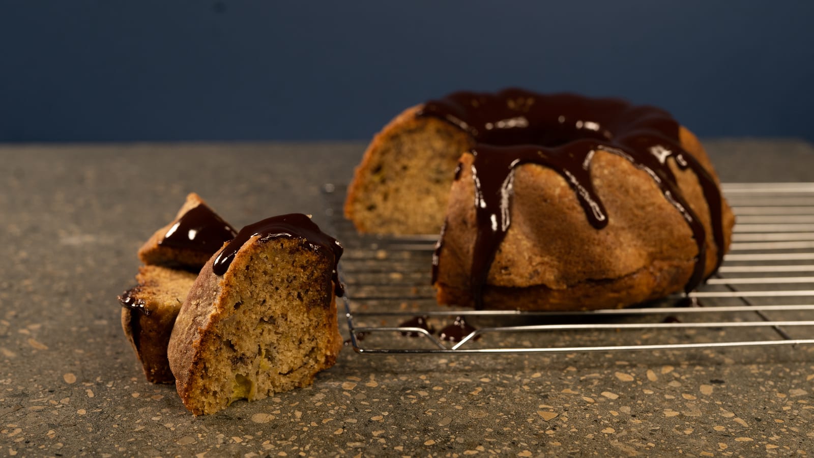 A banana cake with water ganache cut into slices, showing the crumb