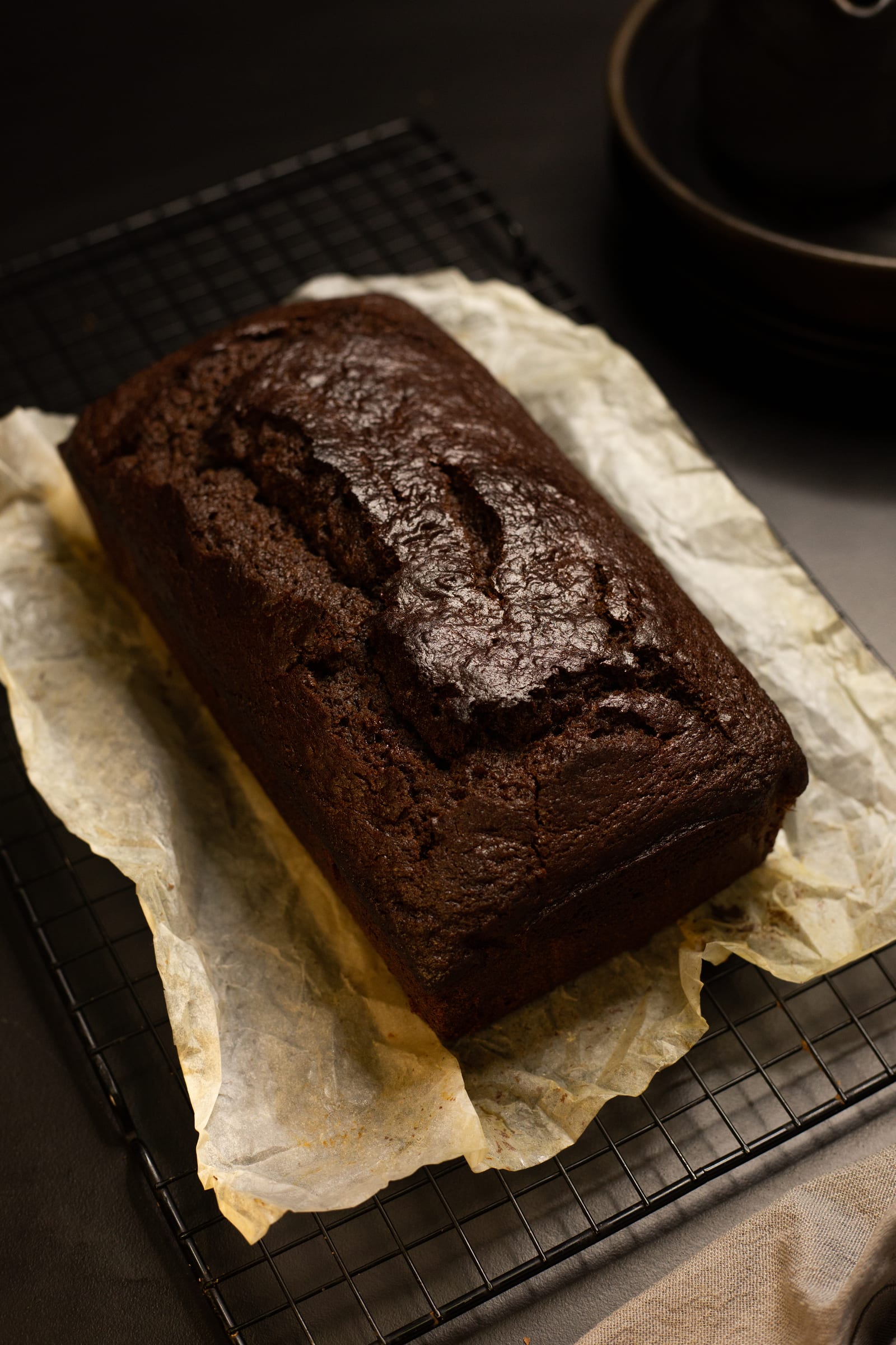 The cracked top of the chocolate banana bread before the ganache goes on