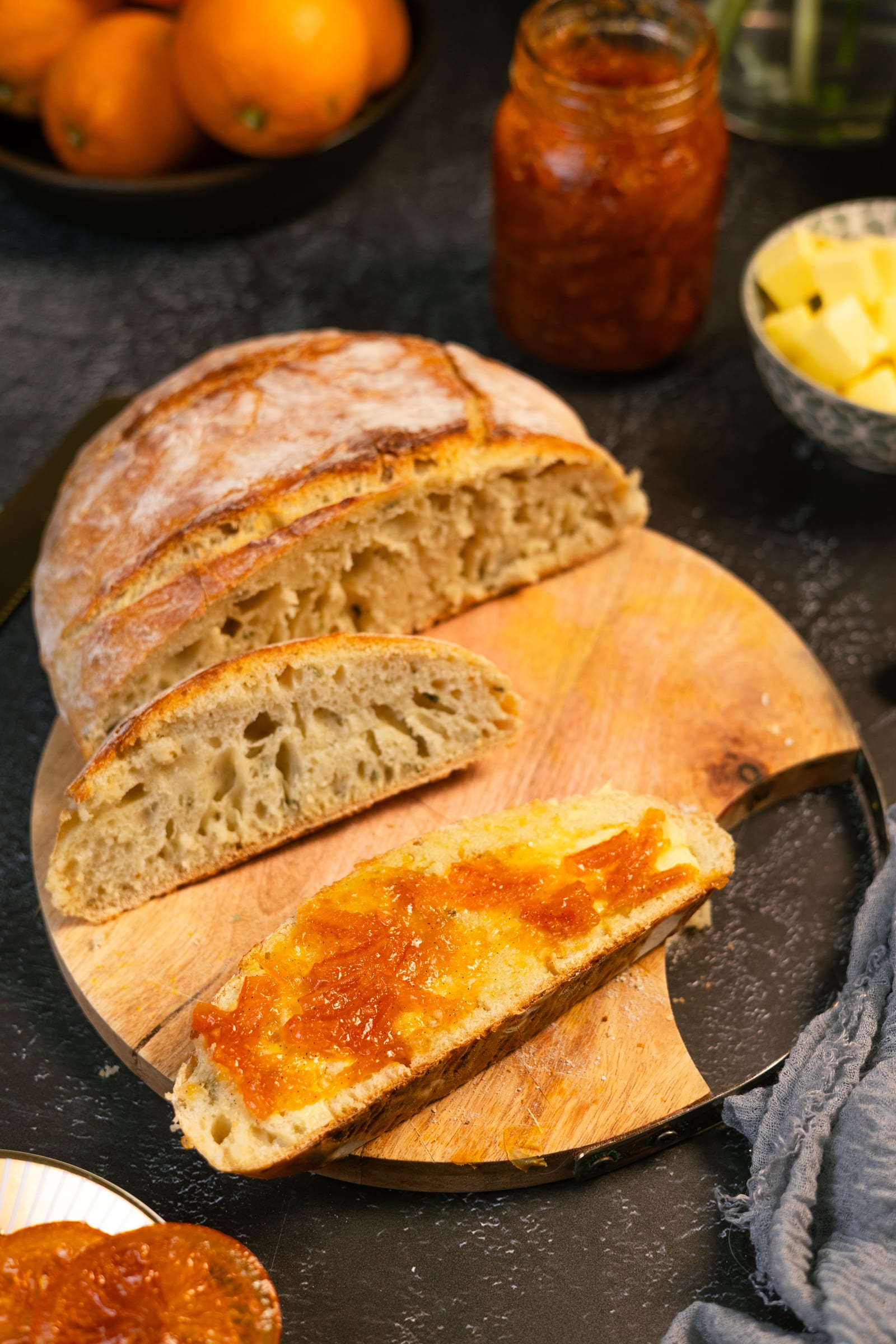 Slices of bread spread with marmalade beside the loaf