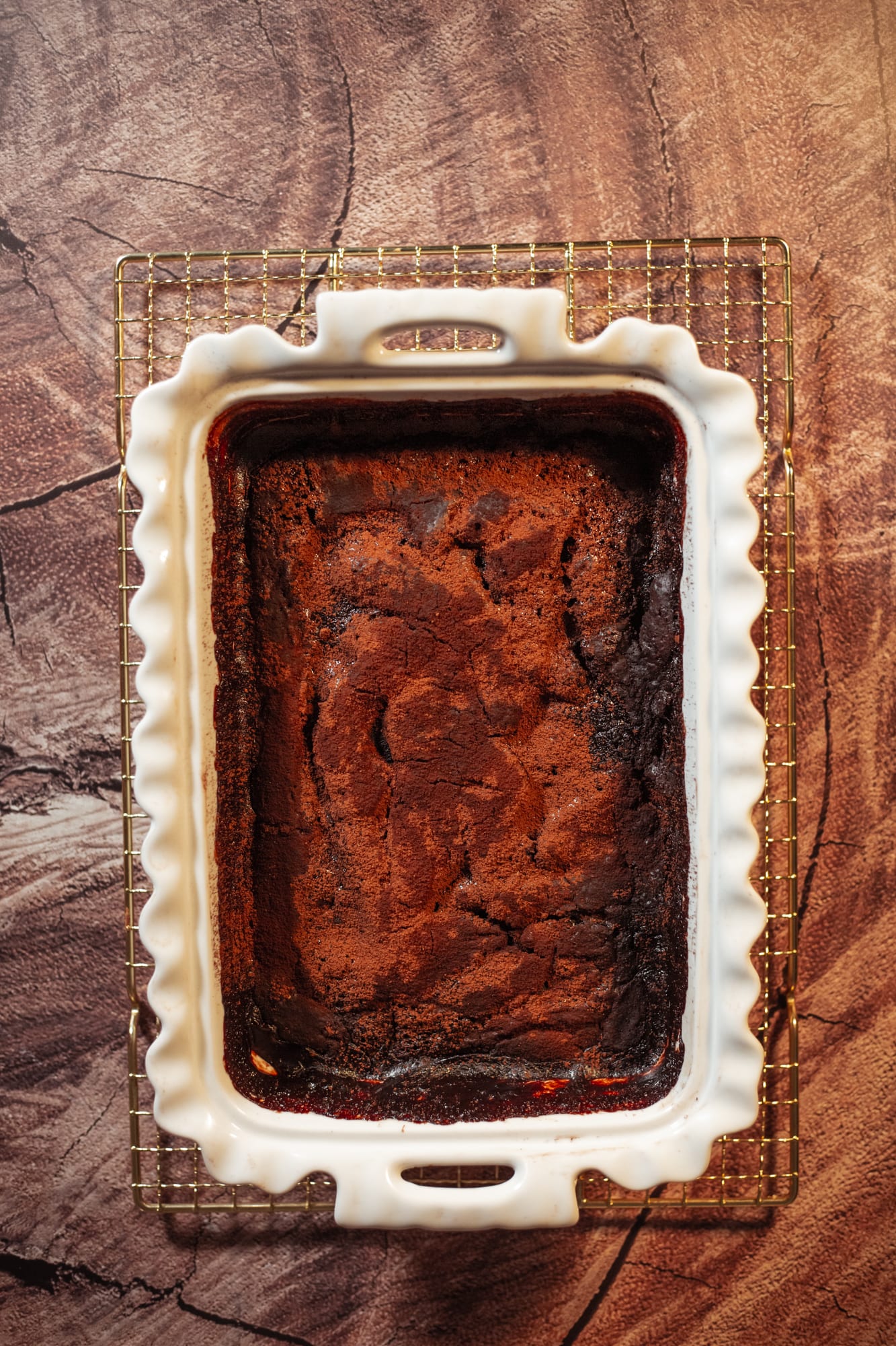 The baked chocolate pudding in a white scalloped dish, from above