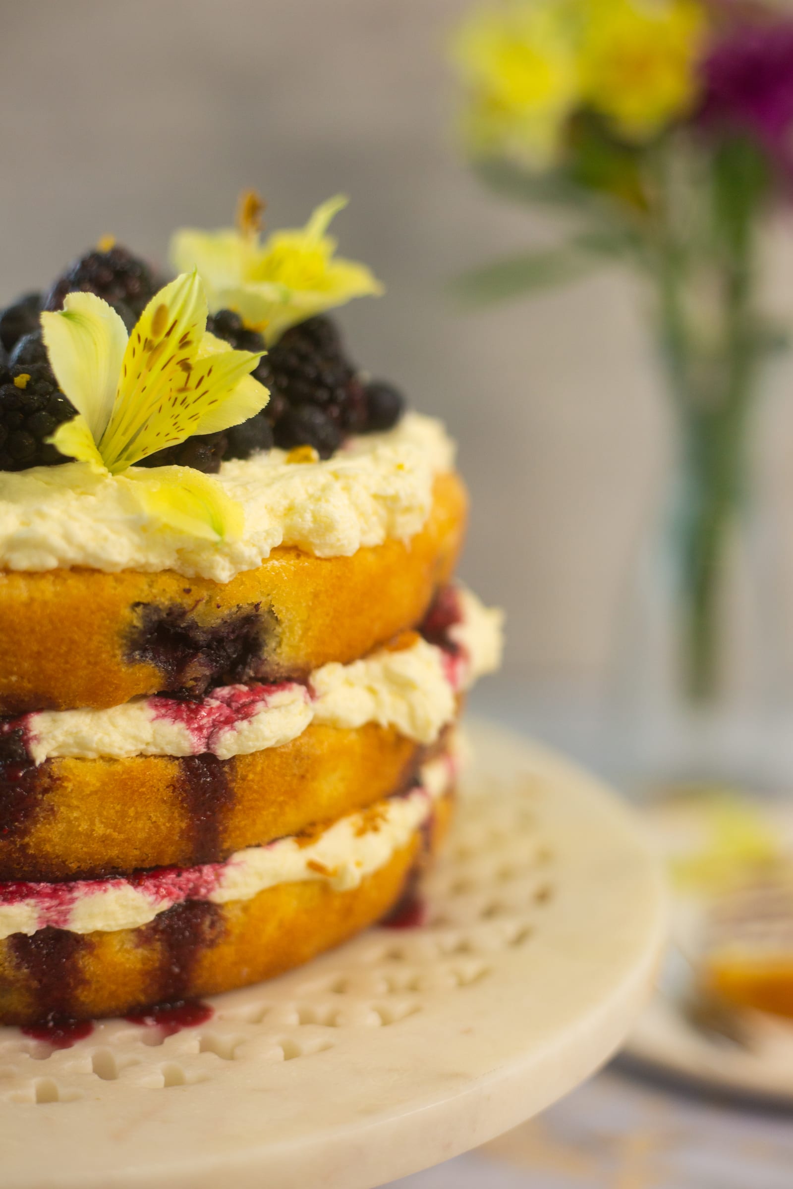 Close-up of the sponges, lemon cream cheese icing and compote in the lemon and blueberry cake