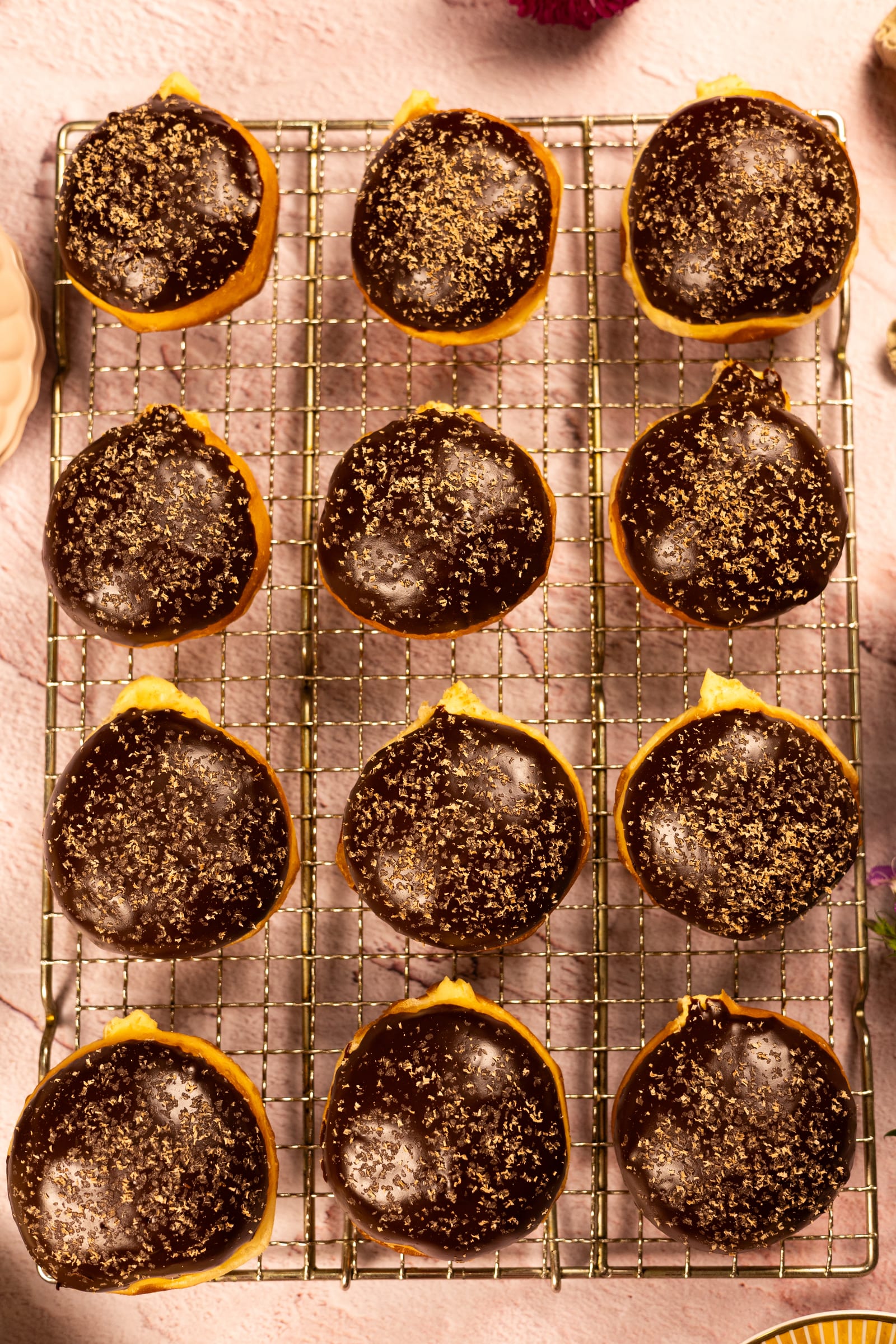 Glazed donuts lined up on a cooling rack, from above